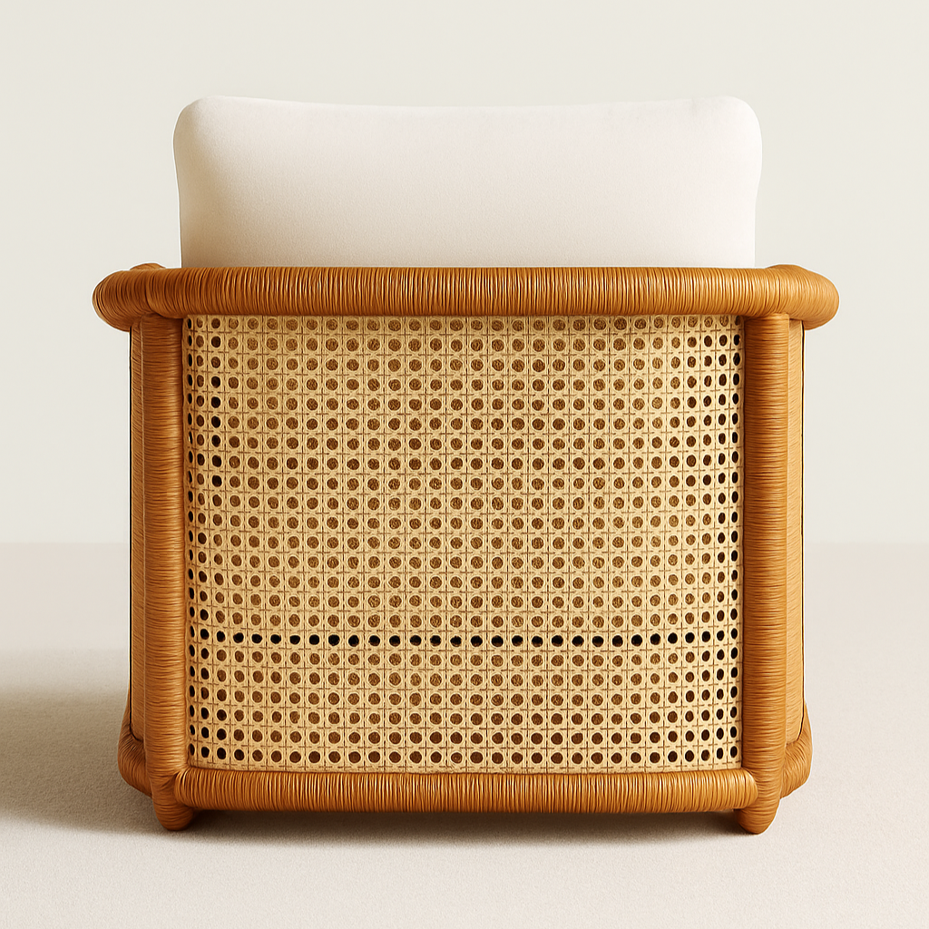 Rear view of an all-weather rattan outdoor accent chair showing a cane-woven back panel framed by rounded natural tan rattan tubing, topped with a cream removable cushion.