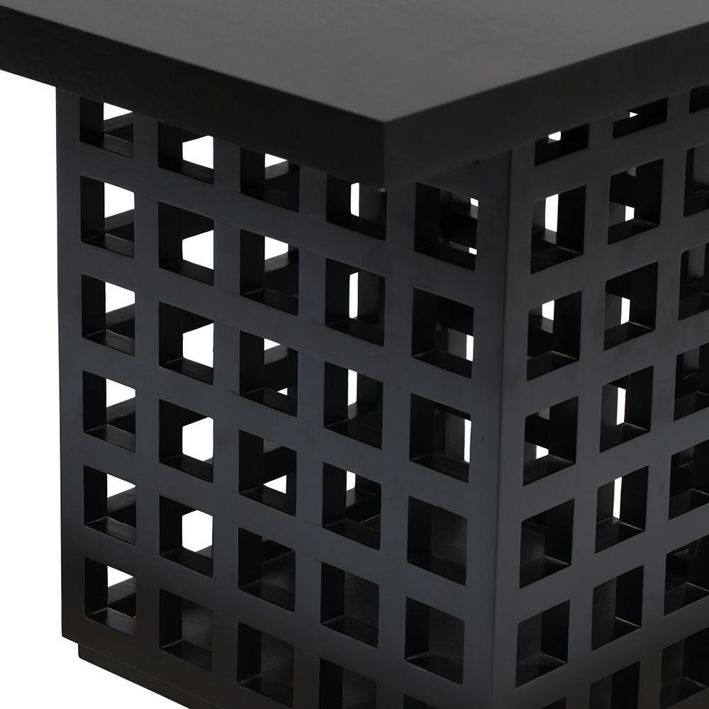 Close-up of a black mahogany solid wood table base with a modern lattice of square cutouts and a thick rectangular tabletop edge.
