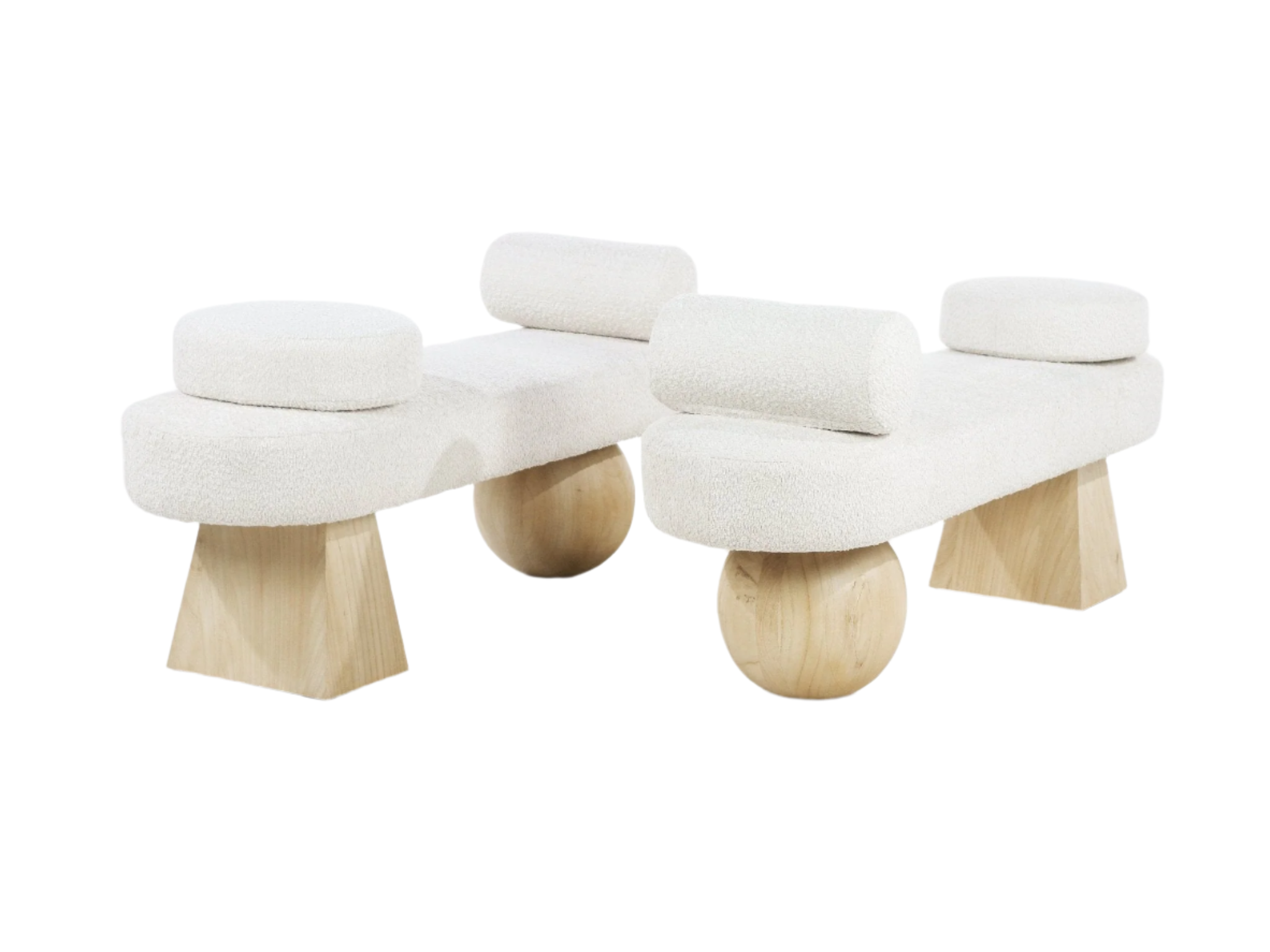 Two backless end-of-bed benches upholstered in off-white boucle fabric, each with round bolster cushions and sculptural natural wood legs combining spherical and trapezoid shapes for a modern coastal look.