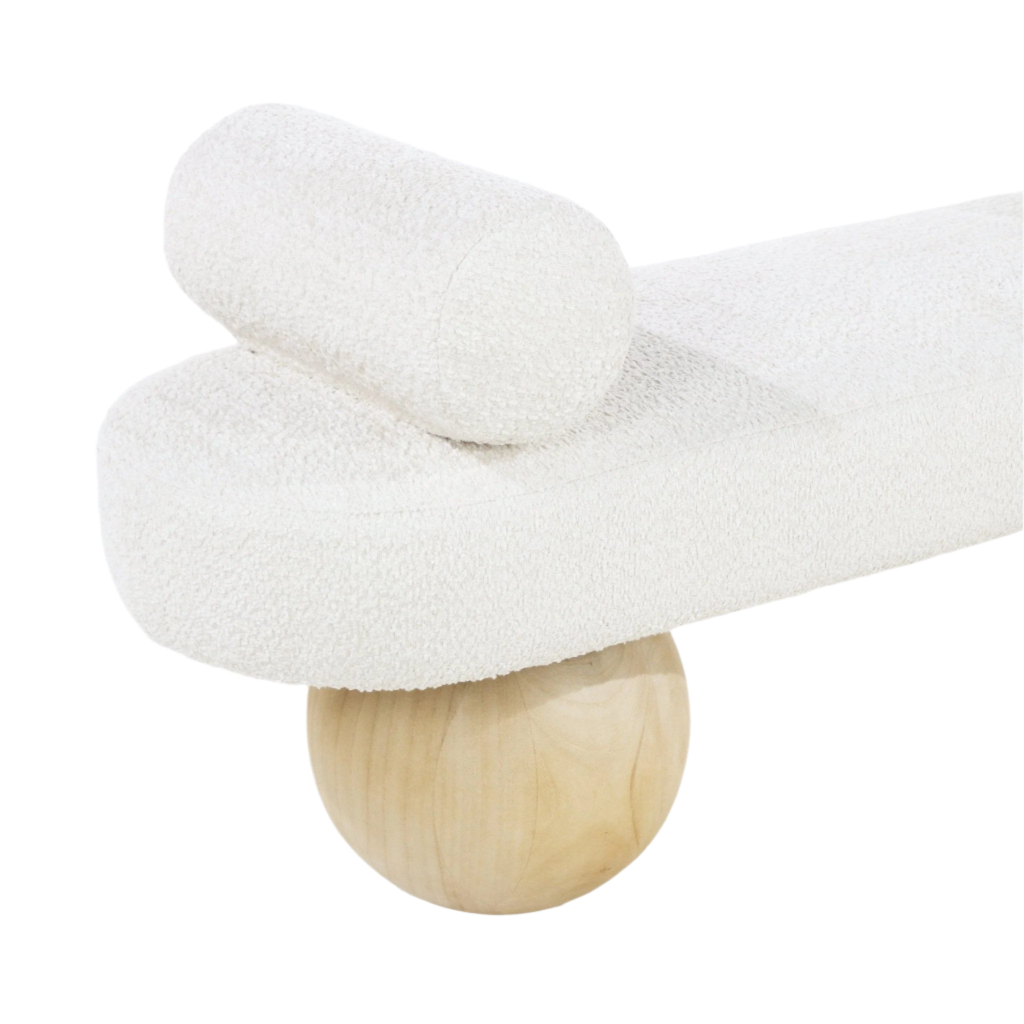 Close-up of a white boucle upholstered end-of-bed bench showing a rounded seat and cylindrical bolster perched on a spherical natural wood leg, highlighting coastal-contemporary fabric and wood materials.