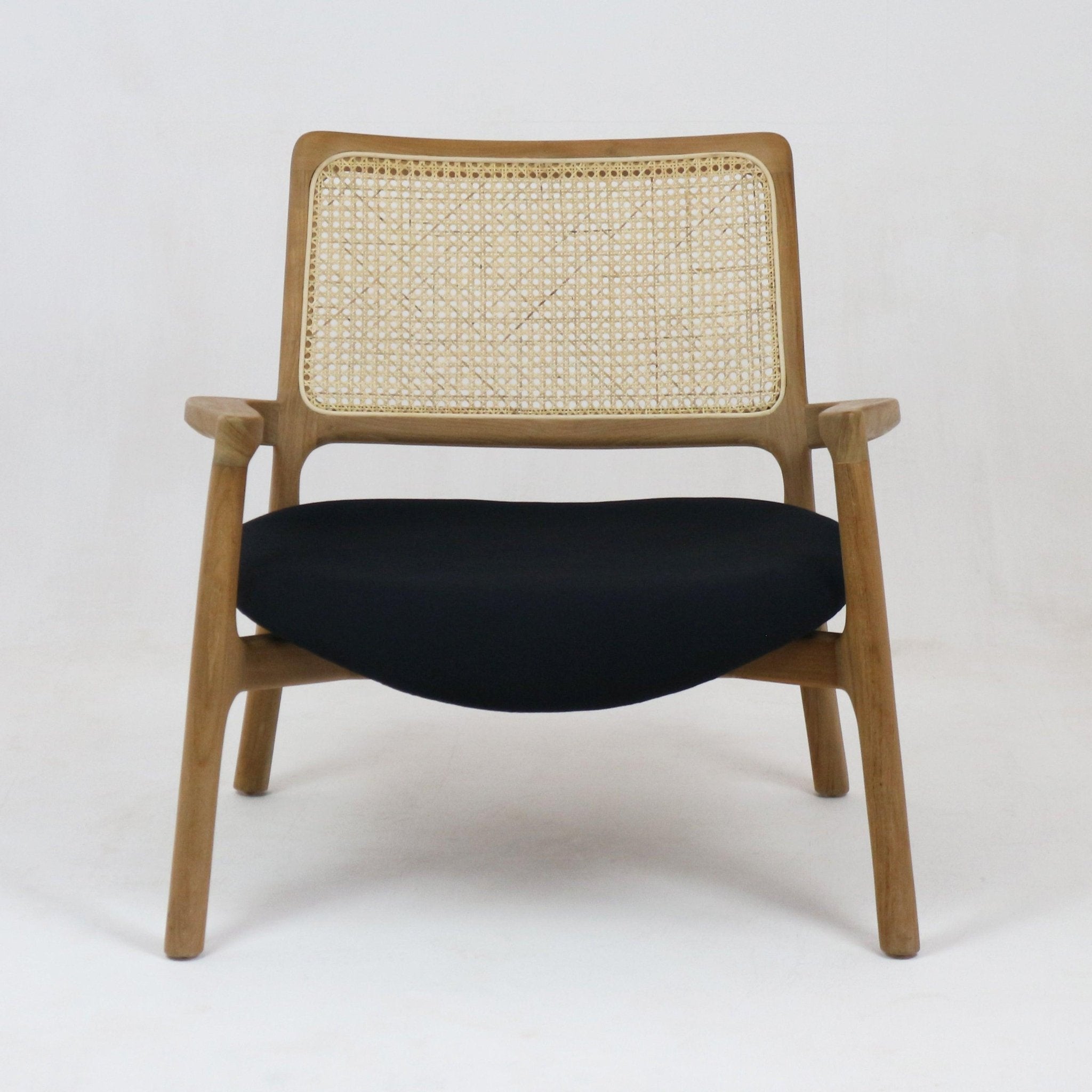 Mid-century modern lounge chair with a solid teak frame, woven cane backrest and a black upholstered fabric seat, shown front-facing on a white studio background.