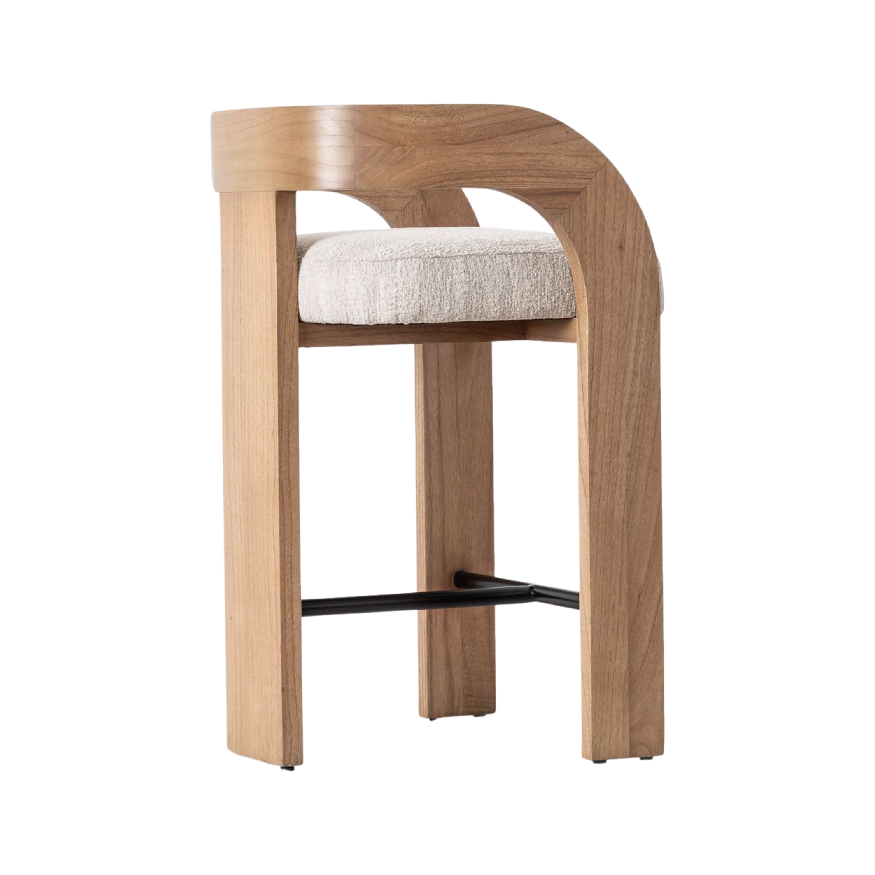 Counter-height stool with cream fabric upholstered seat, curved U-shaped natural wood back and armrest, straight wood legs and a black metal footrest in a modern Scandinavian style.