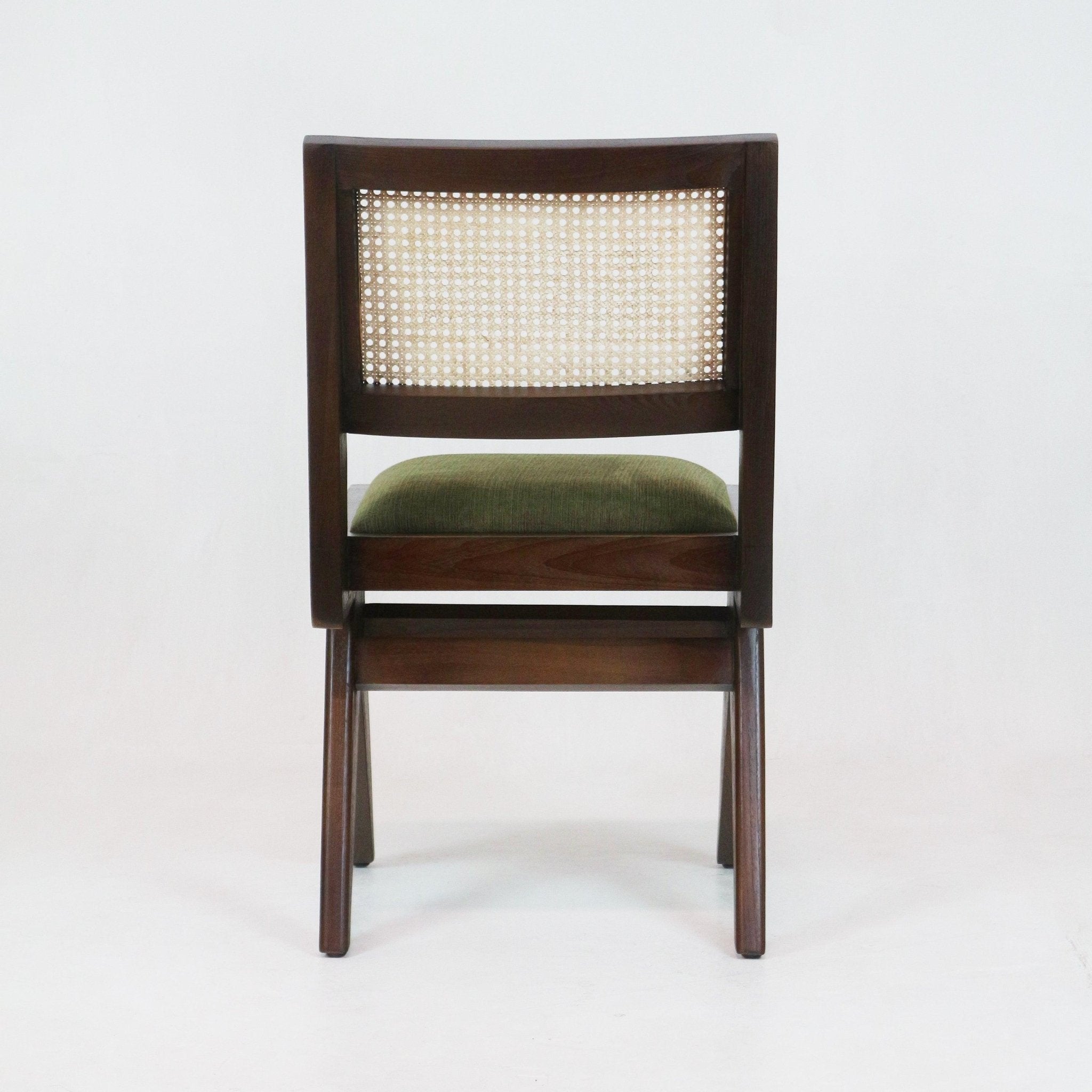 Back view of an armless mid-century modern dining chair with a medium brown solid ash frame, natural cane woven backrest and a green upholstered seat cushion.