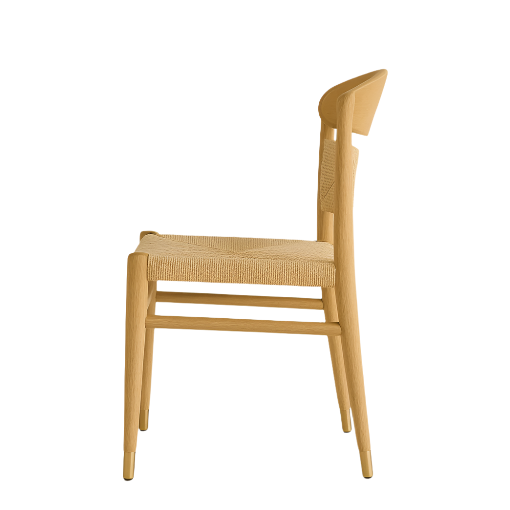 Side view of a mid-century modern dining chair in natural solid wood with a woven seat, curved full backrest, armless profile and tapered legs capped with brass.