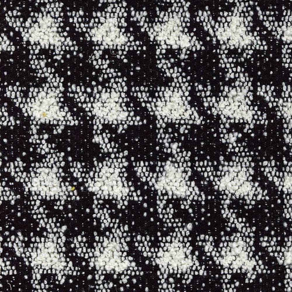 Close-up of black and white boucle upholstery fabric with a textured, houndstooth-like pattern in a wool-acrylic-cotton-polyester blend, shown as a swatch for sofa upholstery.