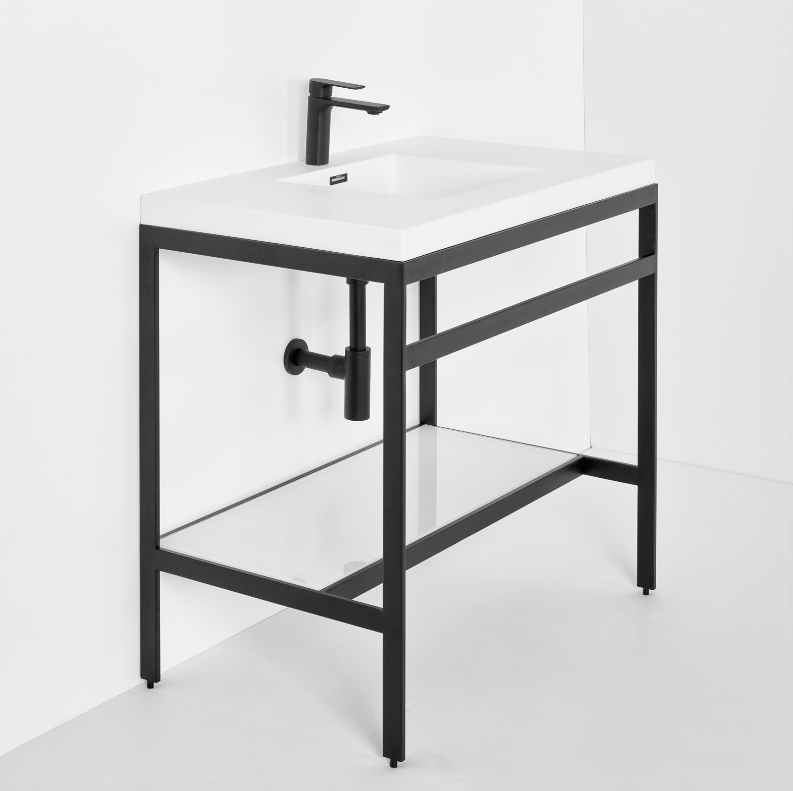 Modern freestanding single-sink bathroom vanity with a white stone top and integrated ceramic basin, supported by a matte-black metal open frame with a lower glass shelf and exposed black drain pipe.