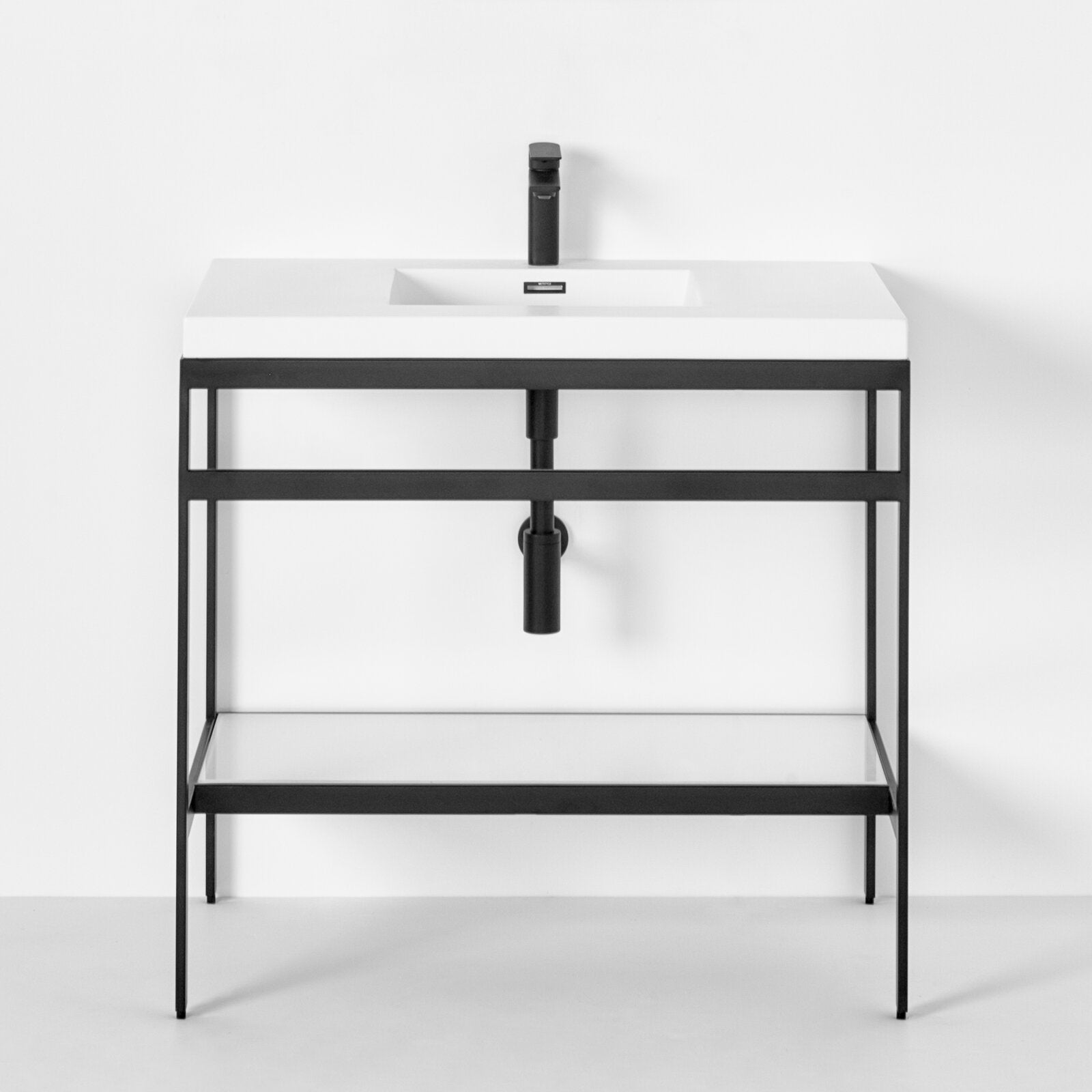 Modern light-stone rectangular sink top with integrated basin mounted on a black metal open-frame console vanity, featuring a matte black faucet, exposed drain pipe and a lower shelf for storage.