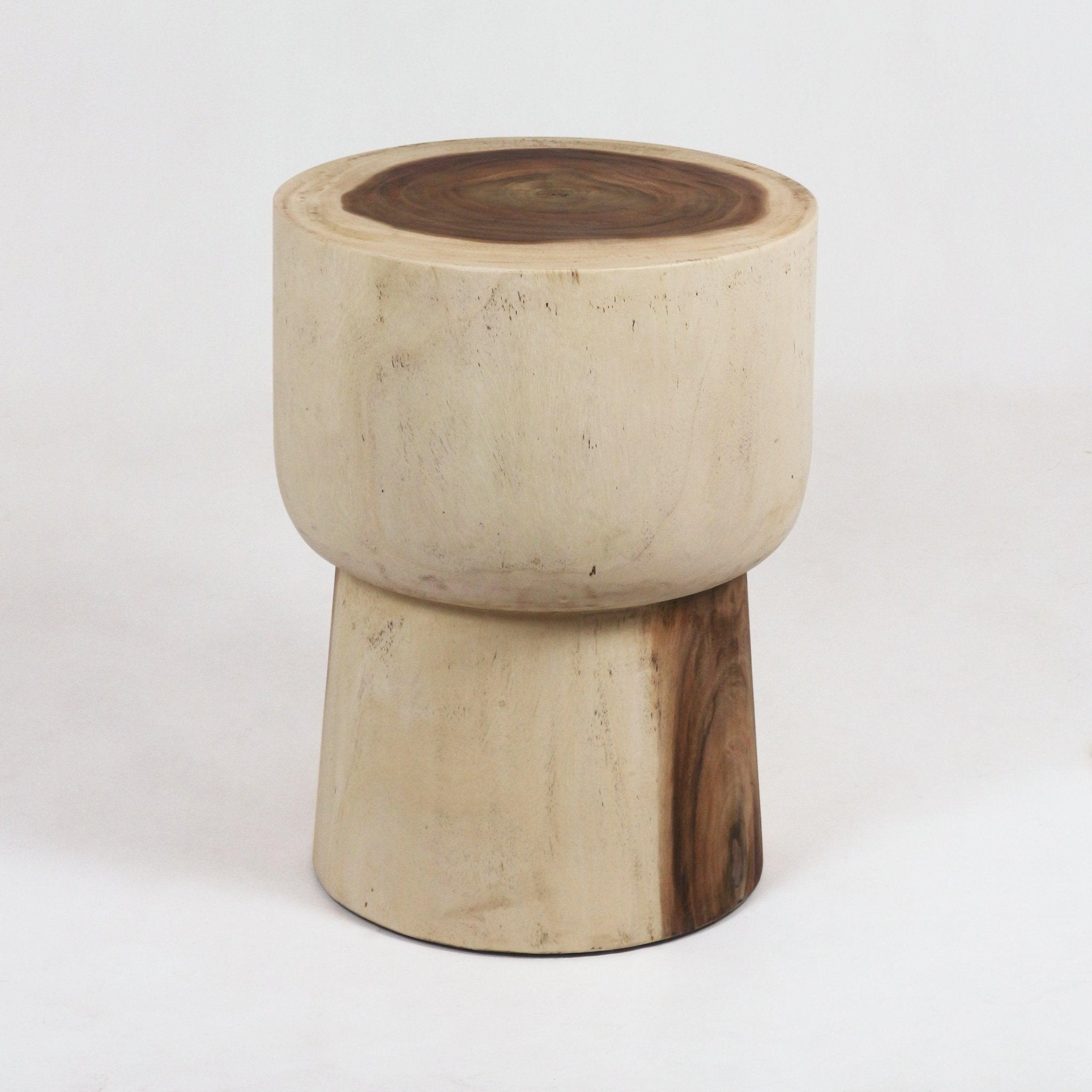 Round solid natural wood stump side table with a smooth light-beige body, darker brown concentric-grain top and a natural brown streak on the base, modern rustic style for living room use.