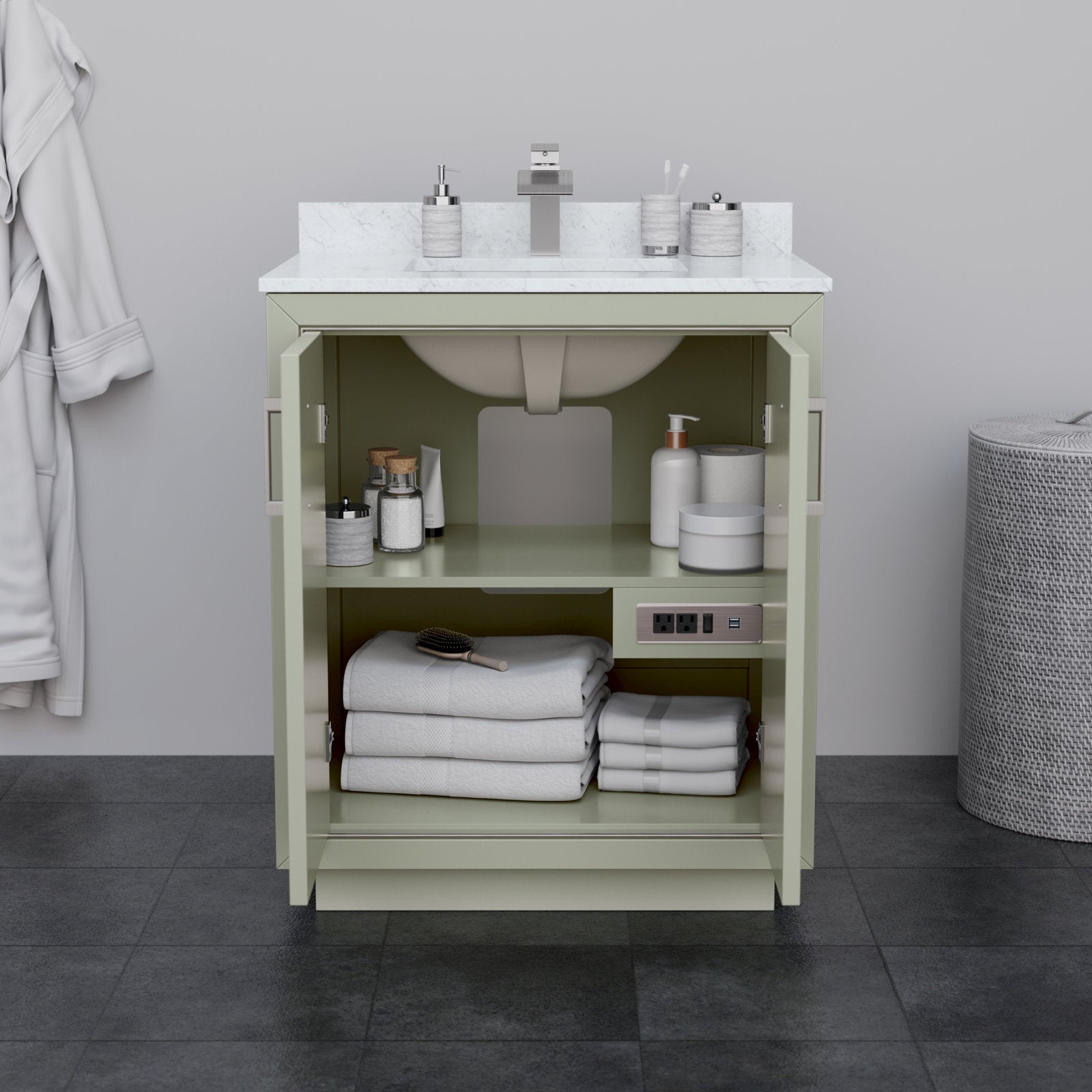 Freestanding modern solid wood 30-inch single-sink vanity with white stone top and integrated ceramic sink; open doors reveal stone-colored cabinet storage with folded towels, toiletries and a built-in power outlet.