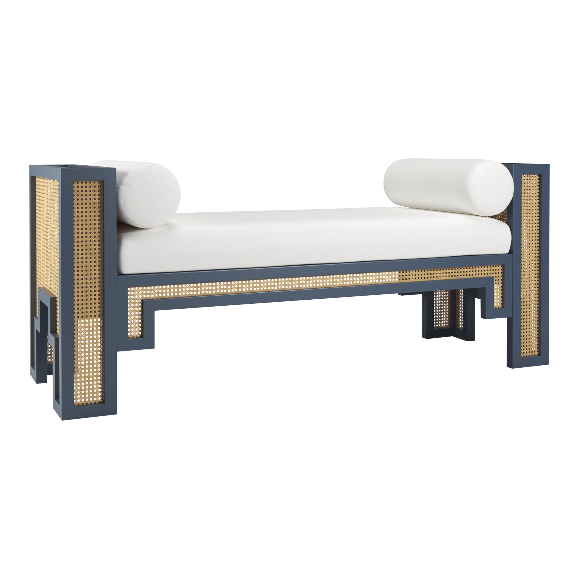 59-inch upholstered end-of-bed bench with a navy solid wood frame, natural rattan cane panels, a white fabric seat cushion and two cylindrical bolsters in a modern boho-Scandinavian style.