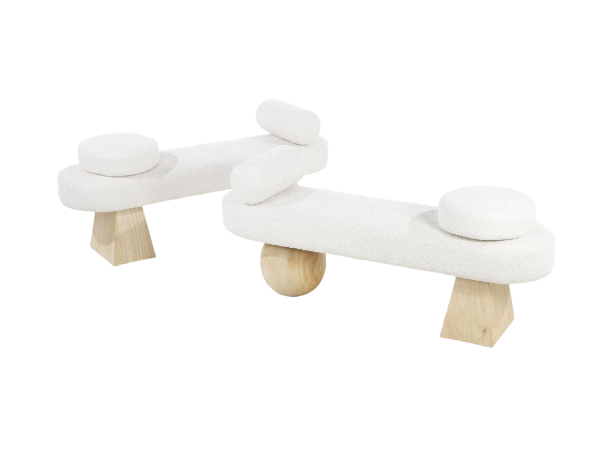 Two cream boucle upholstered end-of-bed benches on a white background, each with natural solid wood geometric and spherical legs, round removable seat pads and cylindrical bolster cushions for a contemporary coastal look.