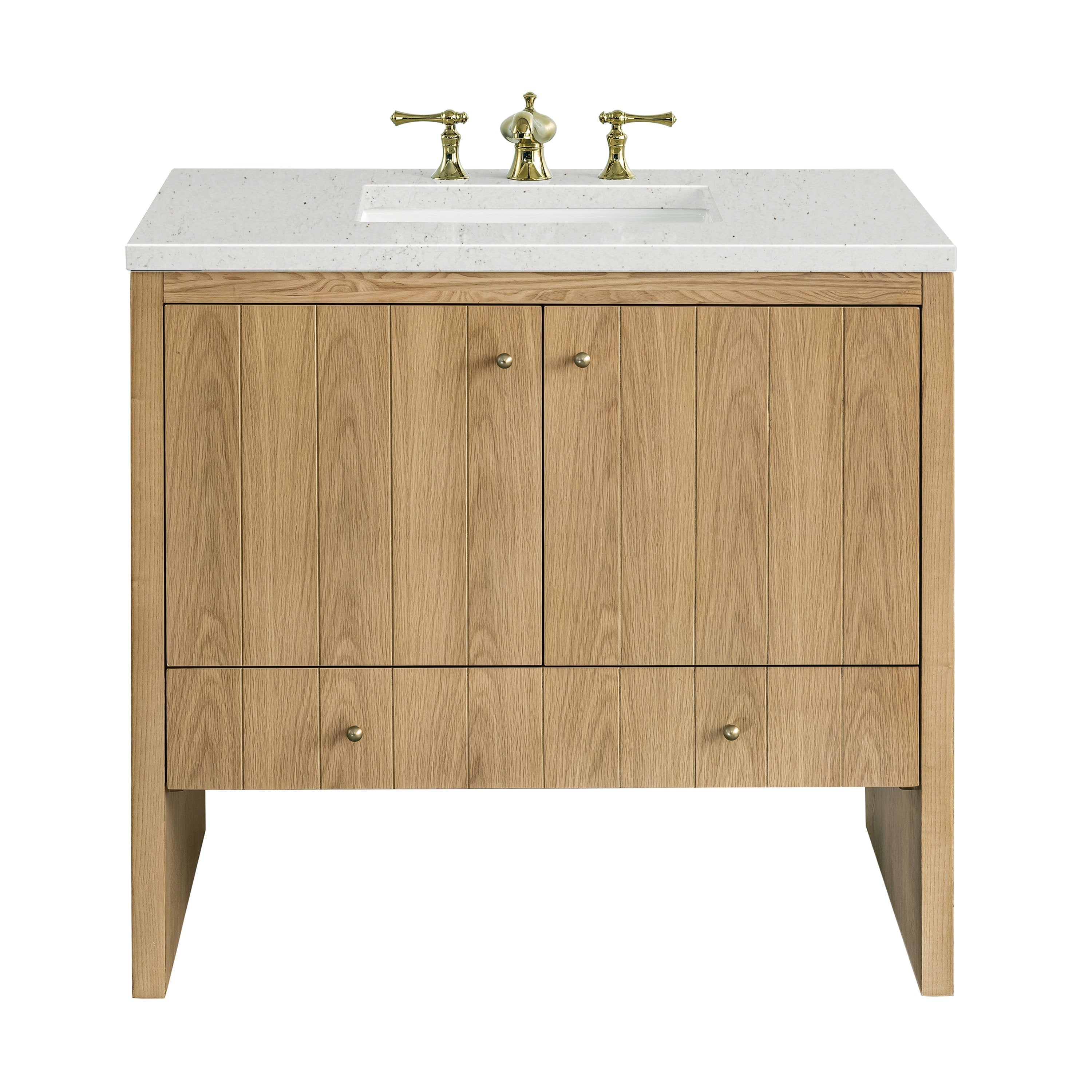 Freestanding 36-inch single-sink bathroom vanity in light natural oak with vertical plank doors, white speckled stone countertop and rectangular undermount sink, fitted with polished brass widespread faucet and round brass knobs.