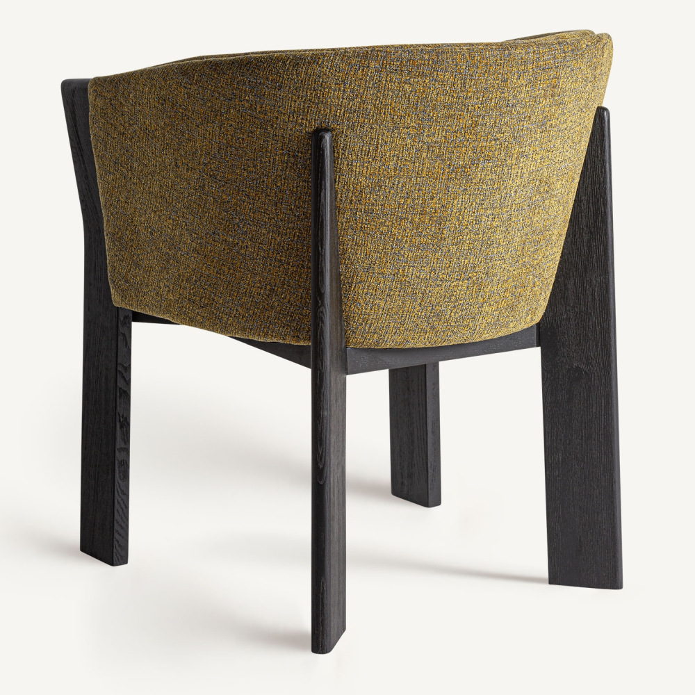 Rear view of a modern dining chair upholstered in mustard-yellow textured performance fabric with a curved backrest and a dark inked oak frame and legs.