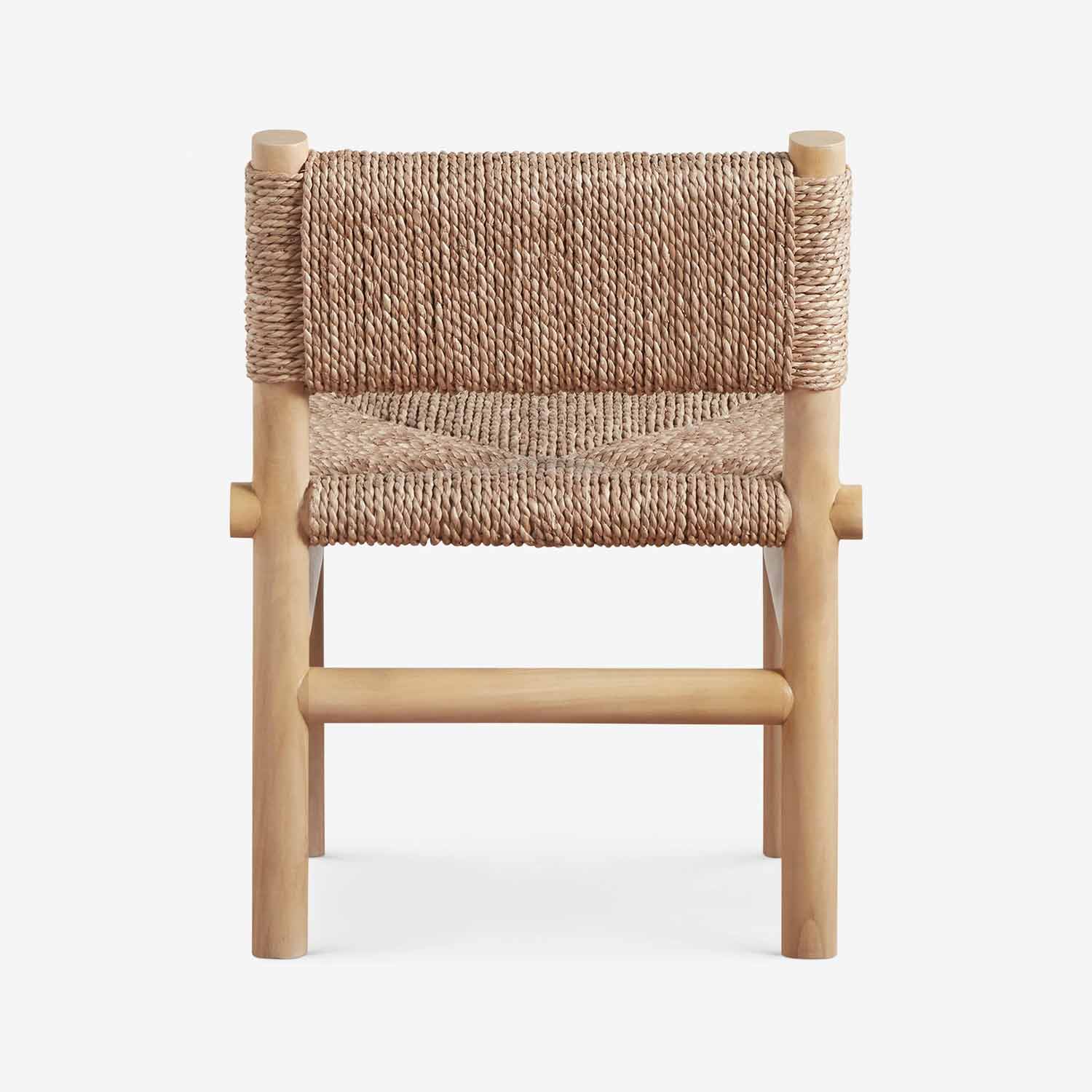 Front view of a natural teak outdoor dining chair with woven rope seat and low back, armless solid wood frame in a light teak finish.