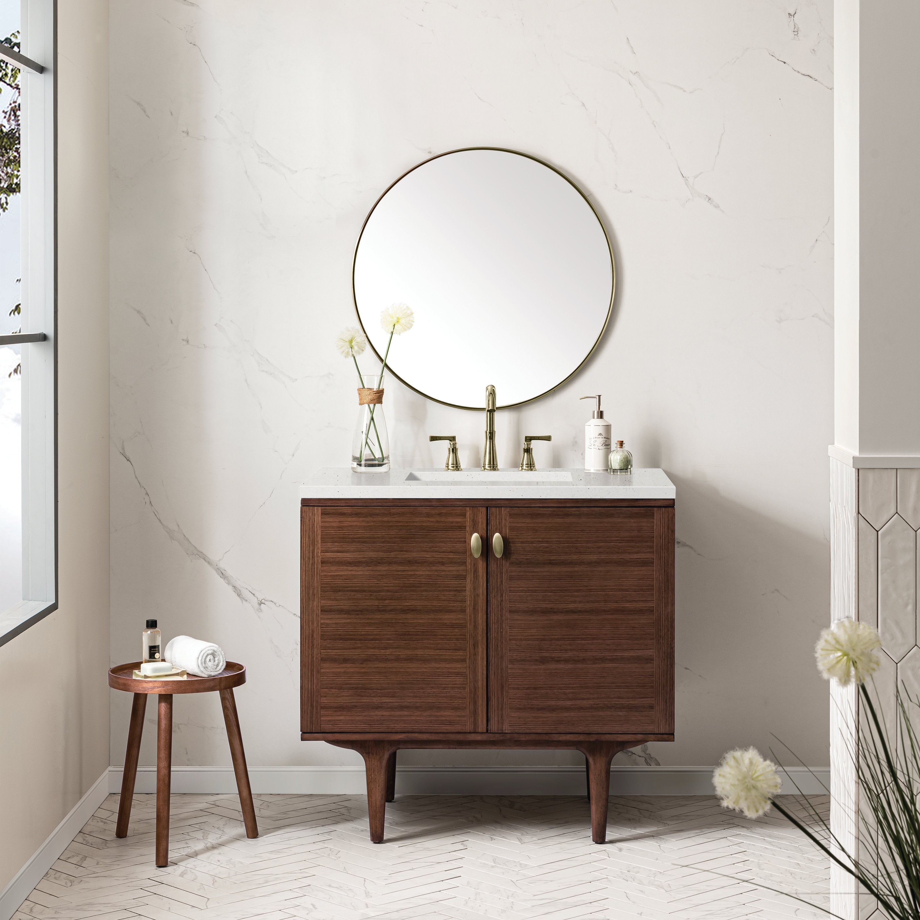 36-inch single-sink modern solid wood bathroom vanity in a warm brown finish with white stone countertop, undermount ceramic sink and brass faucet, shown with a round brass-framed mirror, glass vase and small wooden stool.