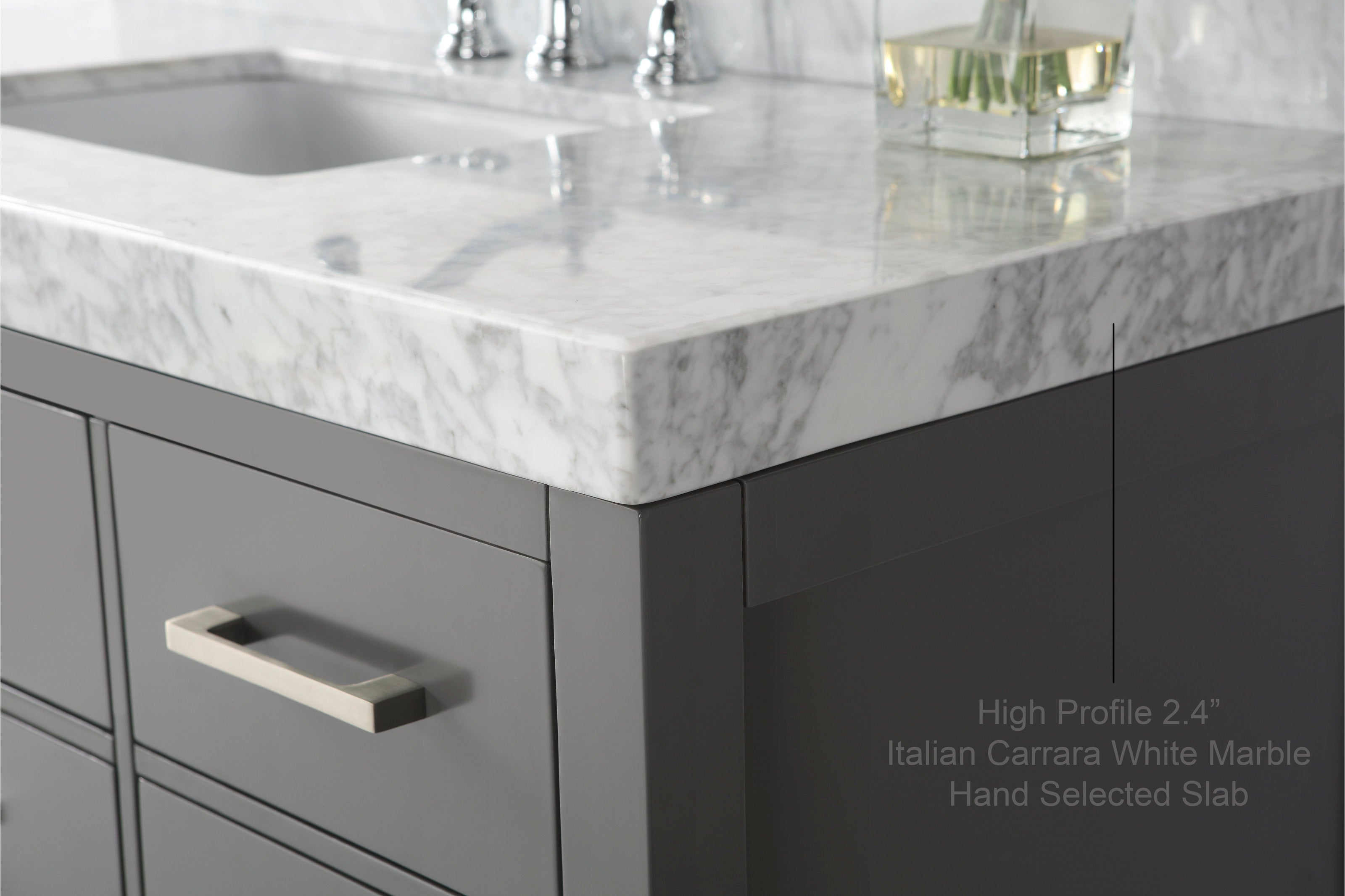 Close-up of a modern stone-gray solid wood bathroom vanity with a high-profile 2.4-inch Italian Carrara white marble countertop, undermount sink, and brushed metal drawer pull.