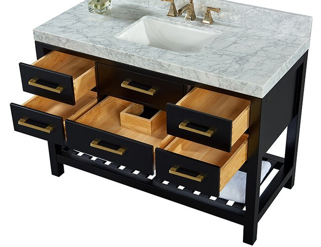 Modern single-sink bathroom vanity with stone marble top and white undermount ceramic sink, black solid-wood frame, multiple drawers with natural wood interiors, brushed gold-tone rectangular handles and a slatted open shelf at base.