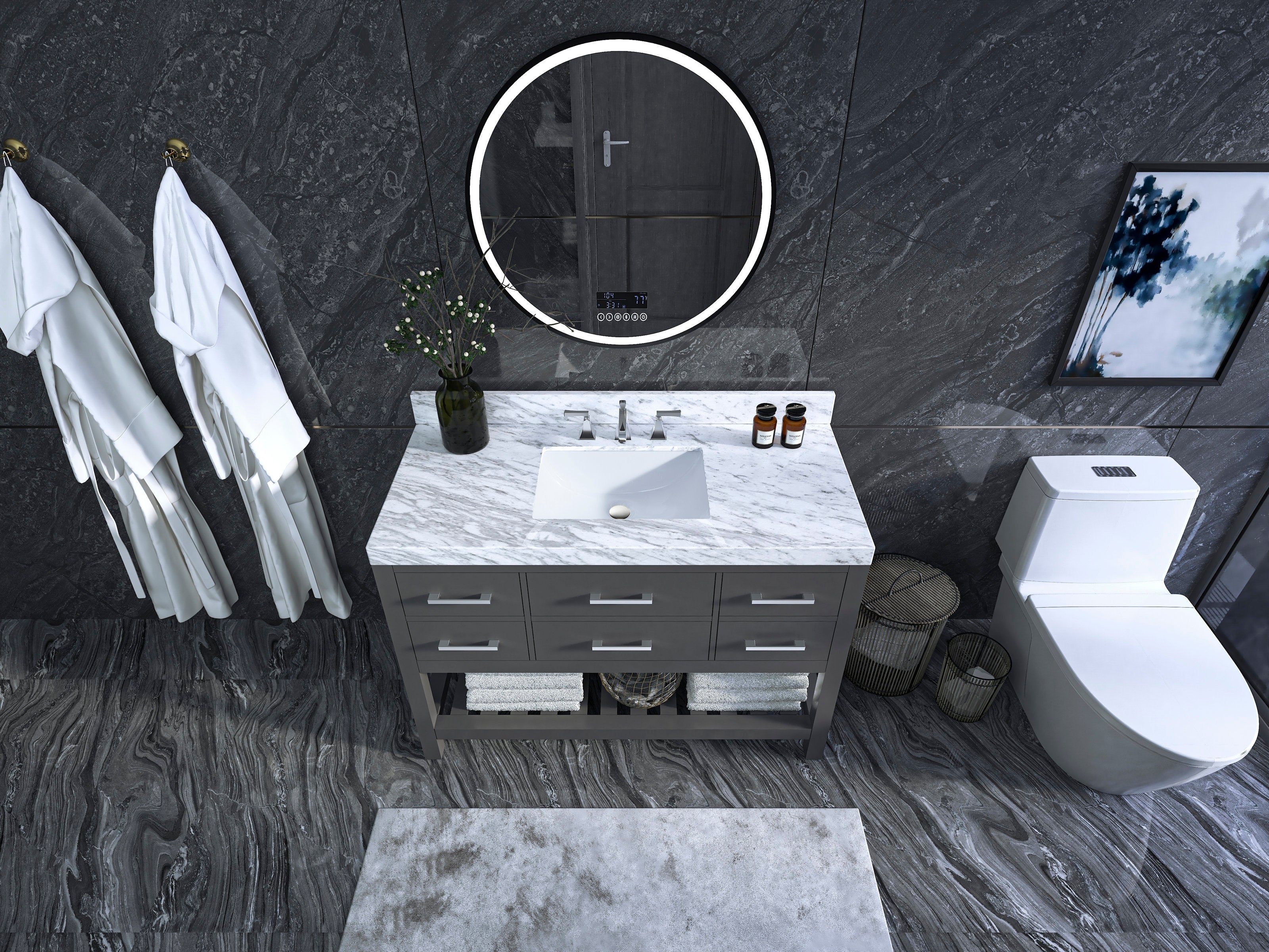 Top-down view of a 48-inch modern single-sink vanity with a white marble countertop, stone-gray solid wood base, integrated ceramic sink, round LED mirror, open towel shelf and white toilet against a dark stone wall.