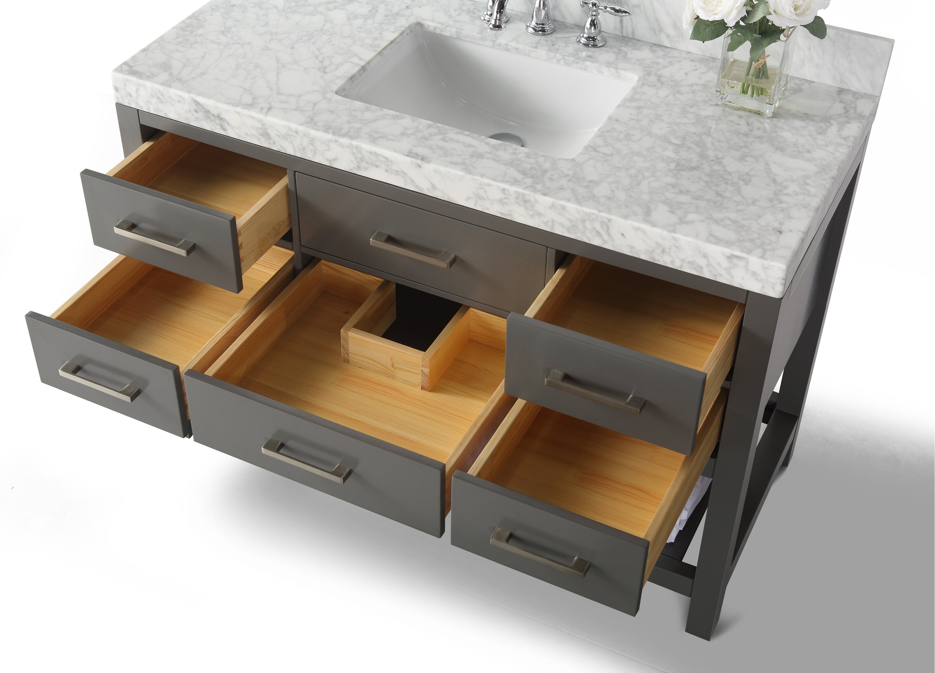 Modern 48-inch freestanding bathroom vanity with a stone marble top and undermount ceramic sink, gray solid-wood base, brushed-metal pulls and multiple open drawers showing natural wood interiors and a vase of white flowers.