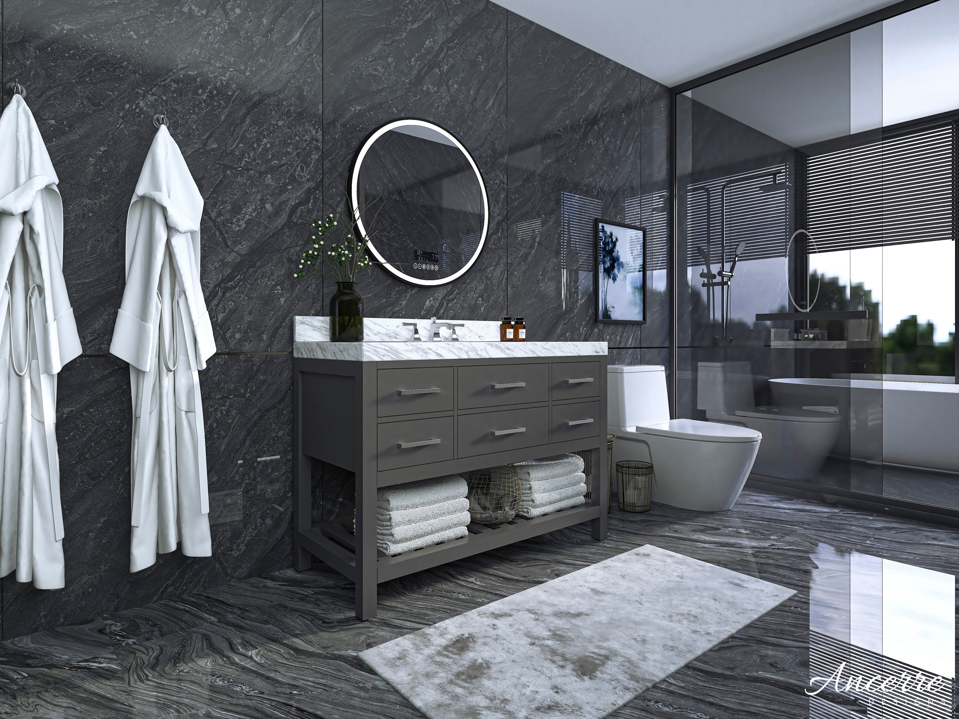 Contemporary solid-wood single-sink vanity in gray with a white marble top, round LED mirror, brushed metal drawer pulls and open shelf with folded towels and basket, shown in a dark stone-walled bathroom with glass shower.