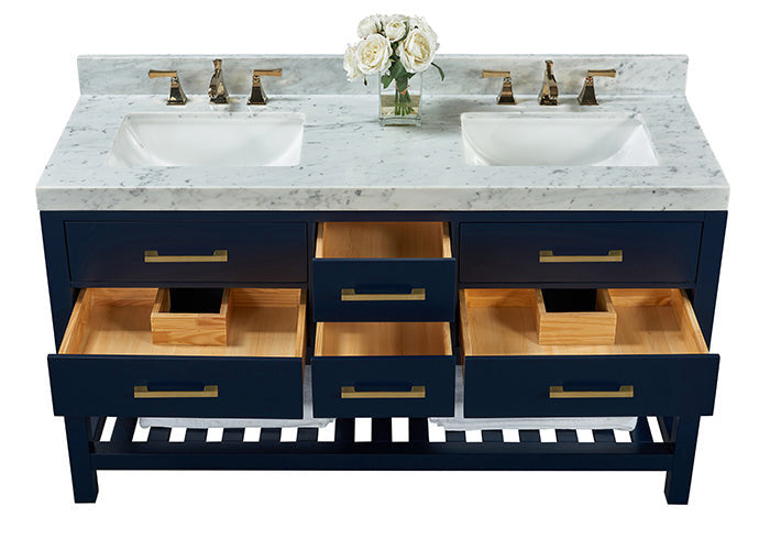 Modern solid wood 60-inch double-sink vanity with a stone marble top, two undermount ceramic sinks, brass faucets and pulls, navy painted wooden base with open drawers showing wood interiors, slatted lower shelf and a vase of white roses.
