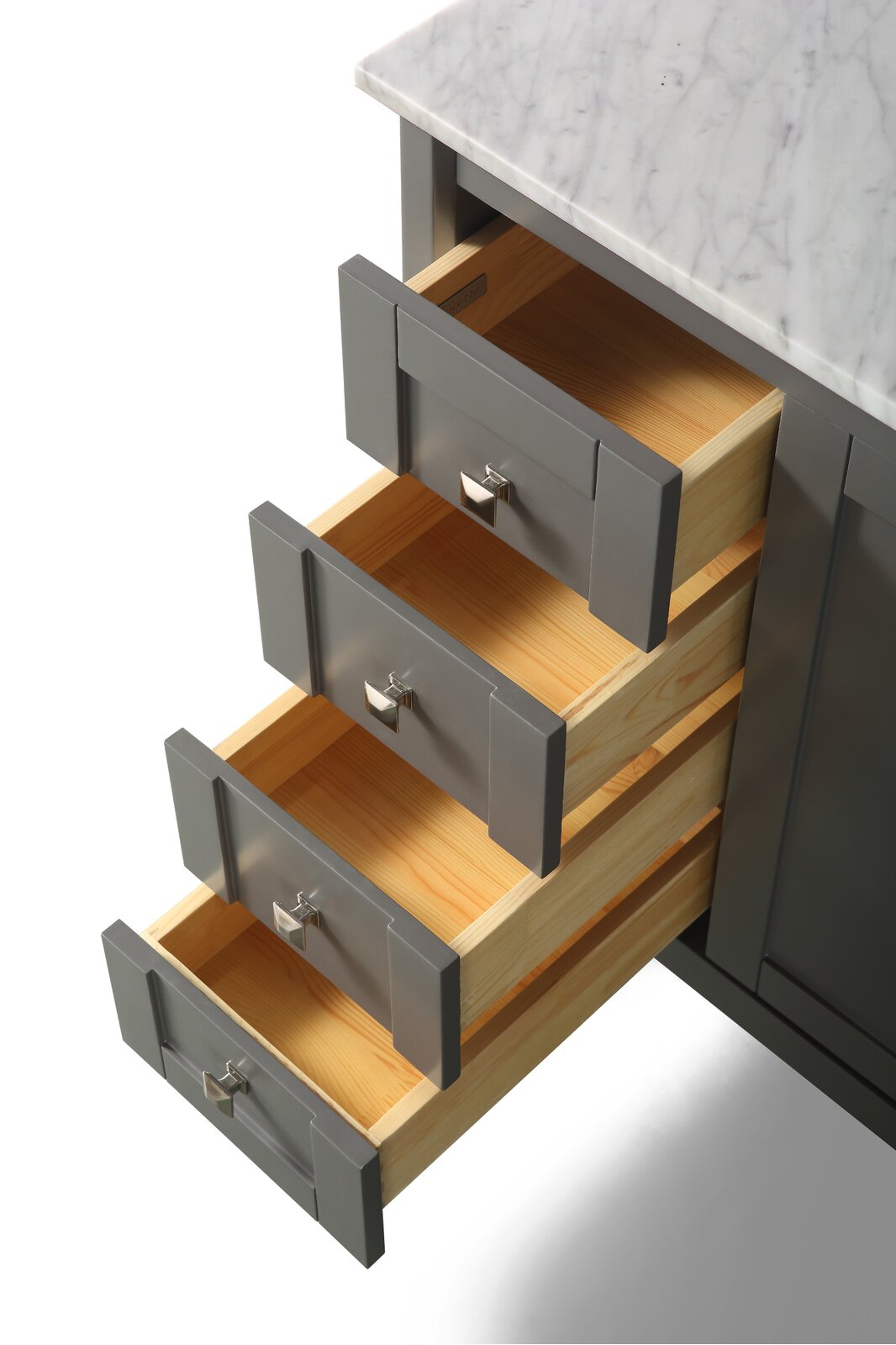 Close-up of a modern bathroom vanity with a white marble stone countertop and four open drawers showing gray painted fronts, square chrome pulls and light solid-wood interiors.