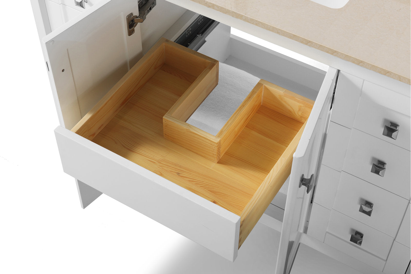 Top-down view of a modern white bathroom vanity with a beige stone countertop, open cabinet and a solid wood U-shaped drawer insert for plumbing clearance, chrome hinge and square metal pulls visible.