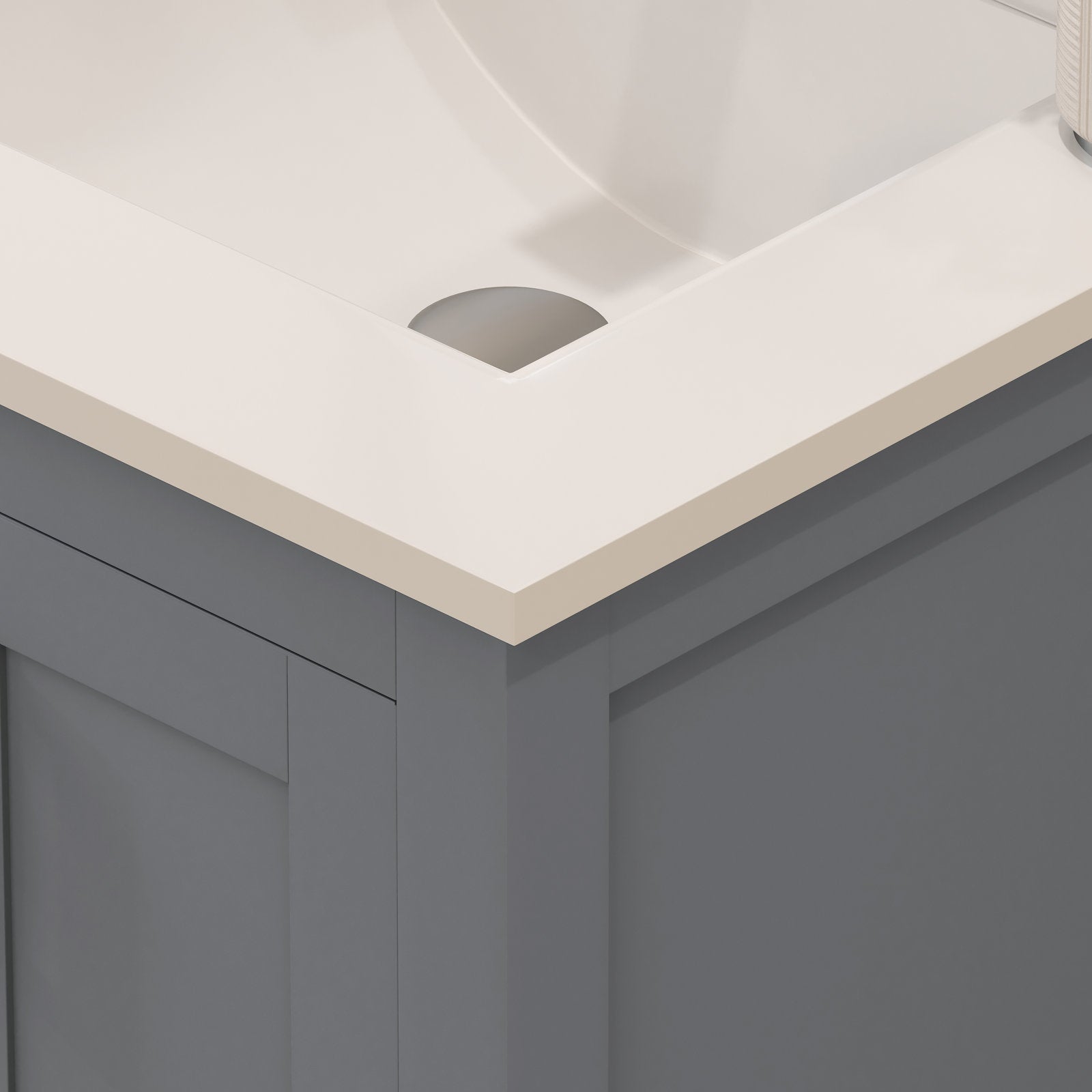 Close-up of a modern solid wood bathroom vanity corner showing a stone-colored countertop with integrated white ceramic sink and a gray wooden cabinet front with clean contemporary lines.