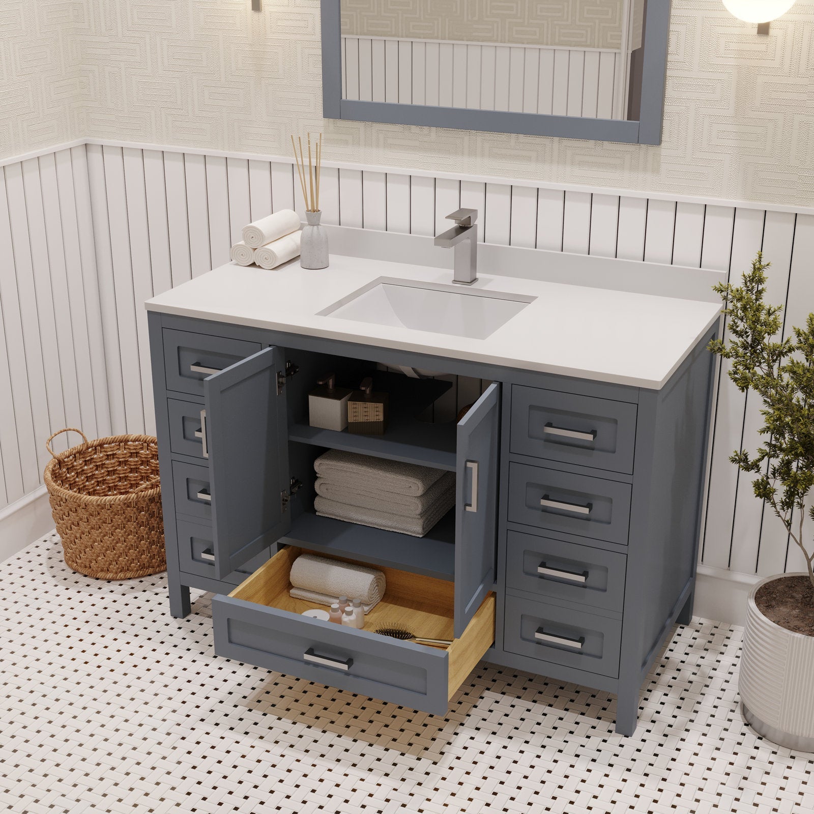 Freestanding 48-inch modern bathroom vanity with a white stone top and integrated rectangular ceramic sink, gray solid-wood base with open cabinet and a pulled-out lower drawer showing folded towels, brushed metal handles and single-lever faucet.