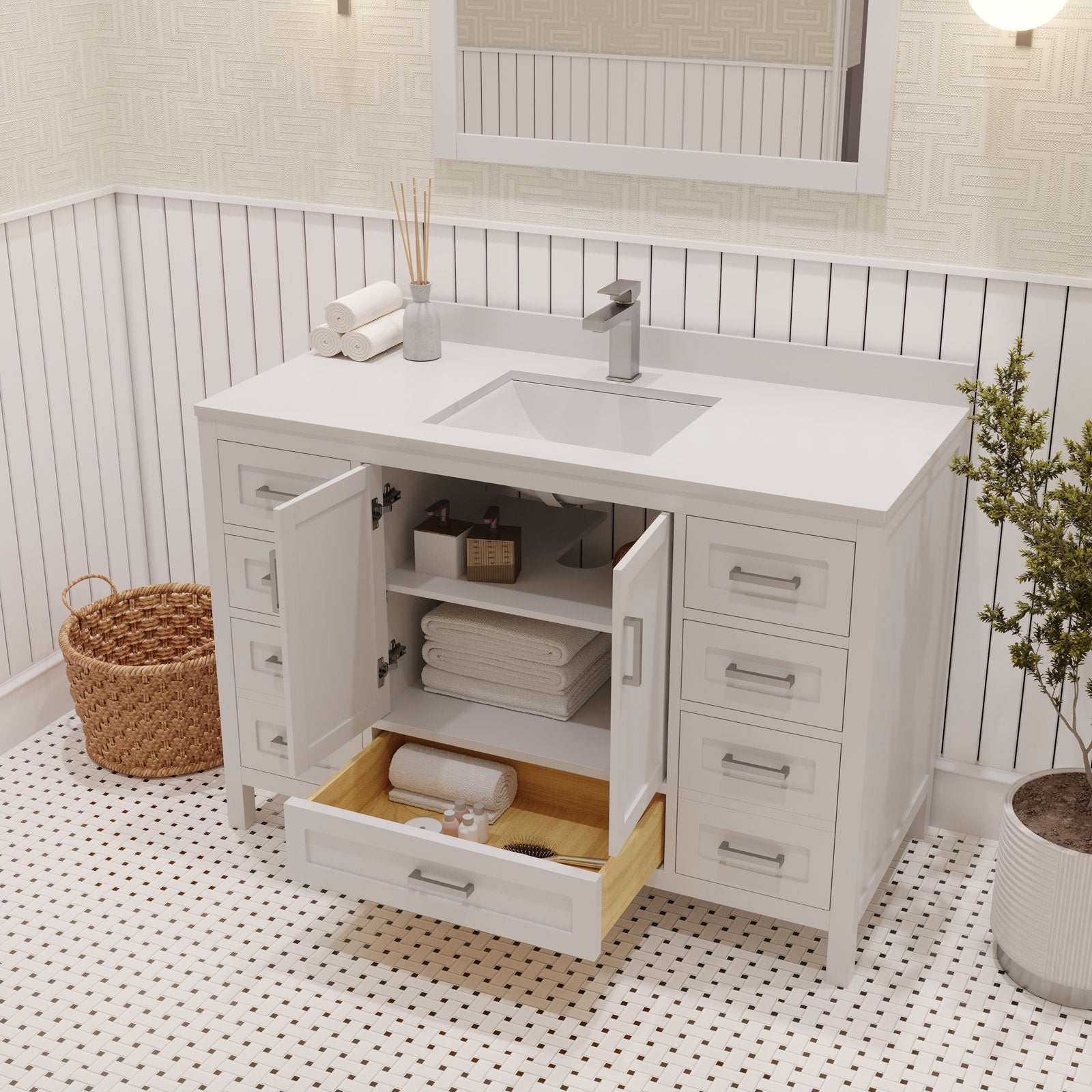 Modern solid wood bathroom vanity with a stone top and integrated ceramic sink, shown freestanding with open cabinet doors and a pulled drawer revealing folded towels and toiletries.