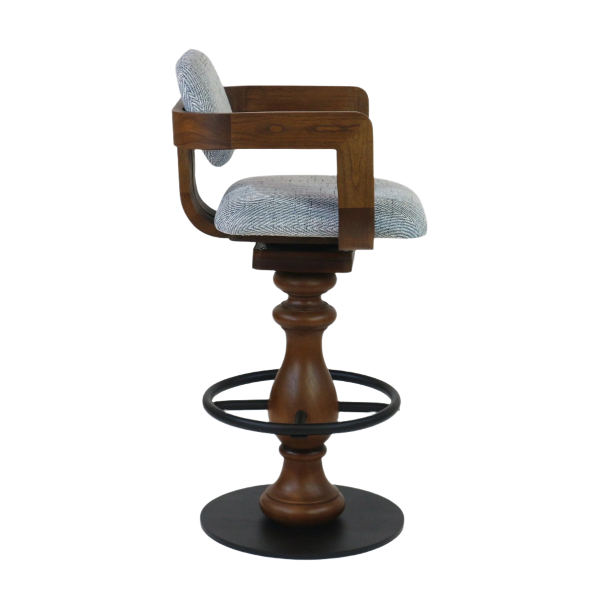 Side view of a counter-height swivel bar stool with light gray herringbone fabric seat and back, walnut-stained wood arms and turned pedestal, and a black metal circular footrest and base.