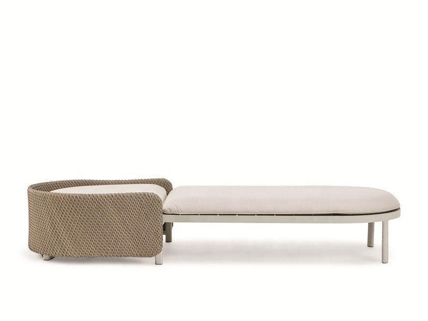 Side view of a coastal sun lounger with a rounded rope-woven natural beige backrest, cushioned light-natural fabric seat cushion and slim metal legs on a white background.