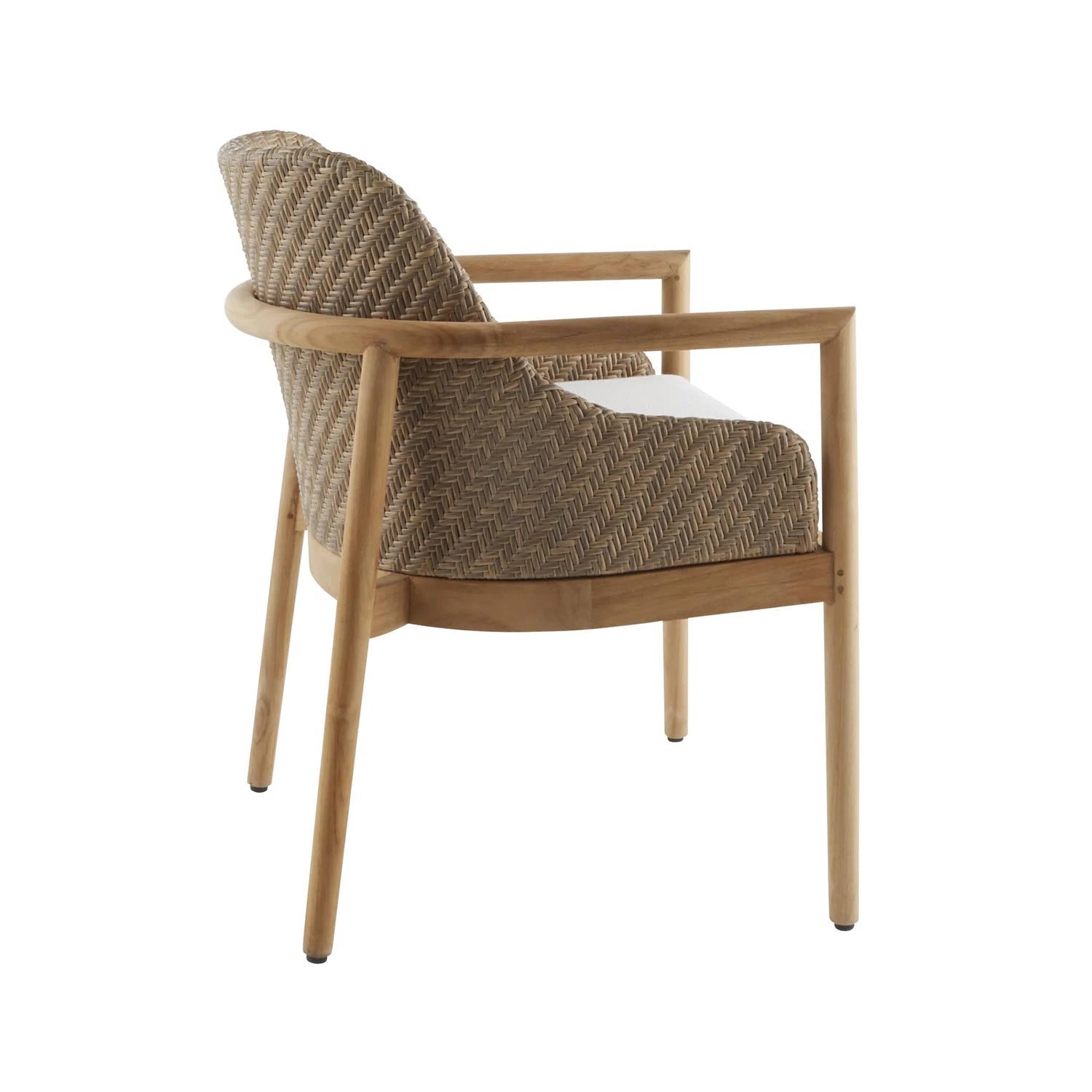 Rear three-quarter view of a coastal outdoor dining chair with a natural teak frame, woven neutral wicker back and sides, and a white fabric seat cushion.