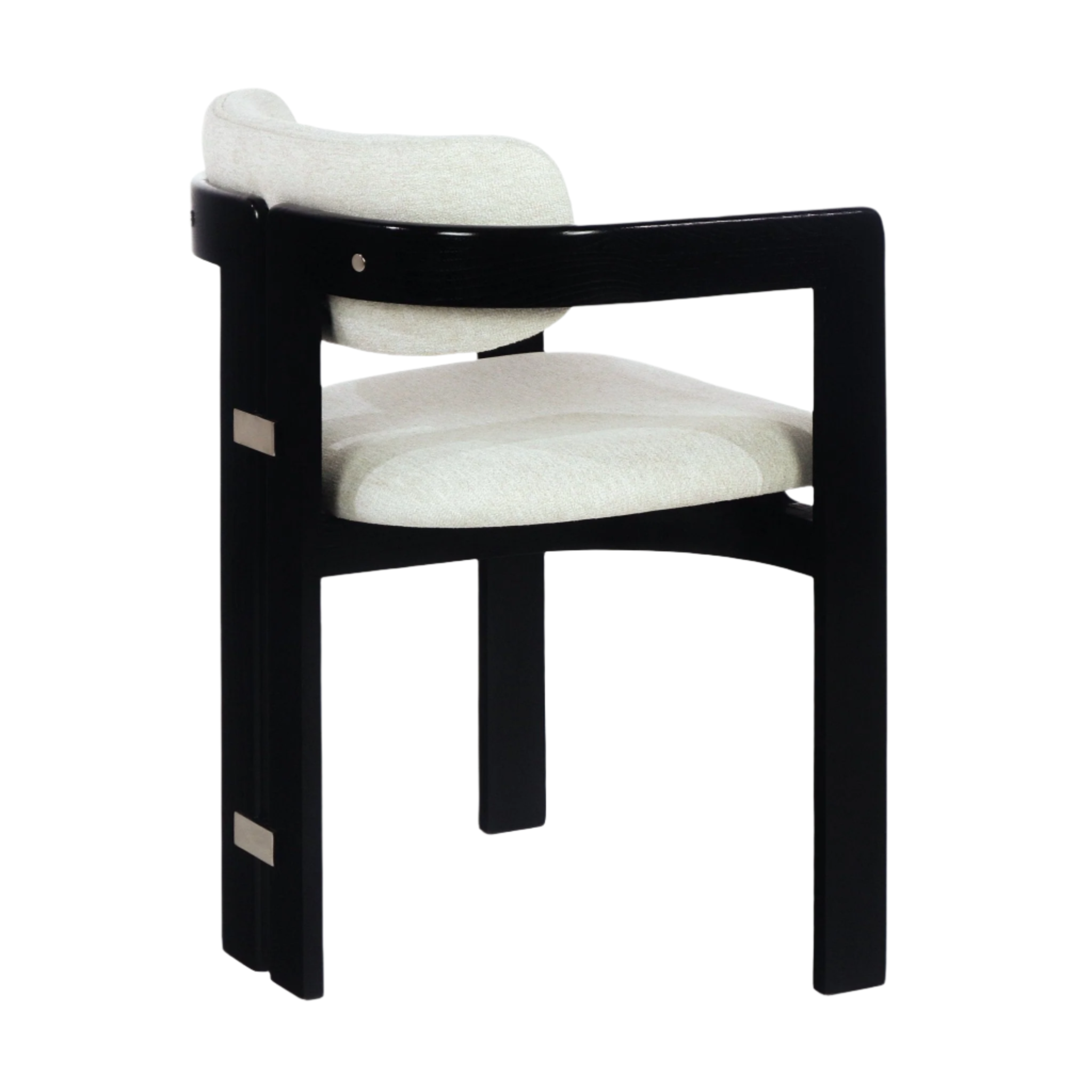 Three-quarter view of a modern dining chair with a black wood frame, curved armback and beige boucle upholstered seat and back cushion, accented with stainless-steel rectangular plates.