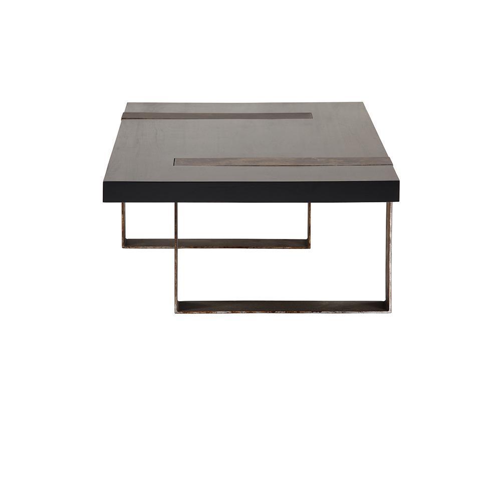 Low modern industrial rectangular coffee table with a thick black mahogany wood top with two inset mahogany strips, supported by U-shaped steel legs finished in aged bronze.