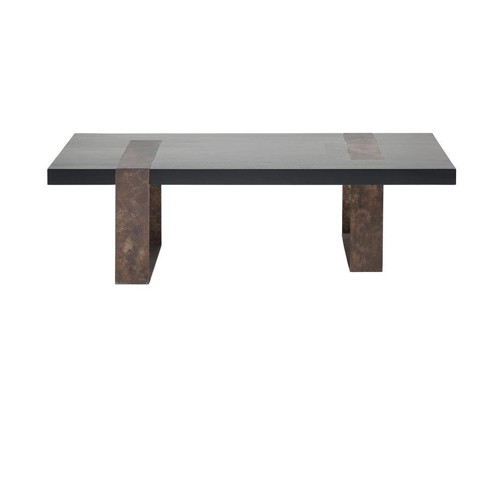 Low rectangular modern coffee table with a black mahogany solid wood top and two wide rust-brown steel block legs with an industrial patina, shown on a white background.