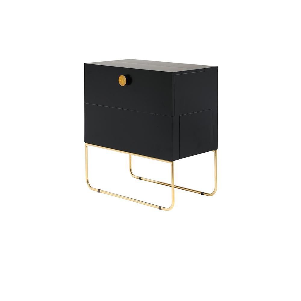 Compact mahogany-finish drinks cabinet in black with a round brass knob and slim polished brass sled legs; two-drawer contemporary glam storage piece shown on a white background.