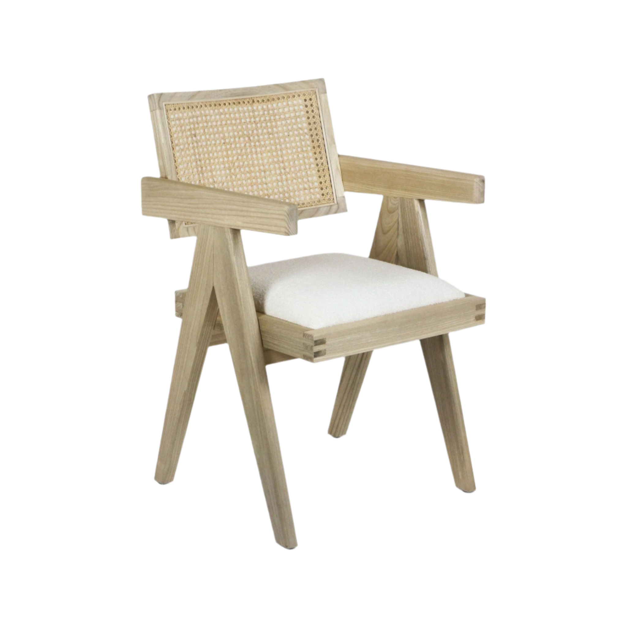 Mid-century modern natural wood dining chair with woven cane back, angled legs and broad wooden arms, fitted with a white upholstered boucle seat cushion and visible joinery details.