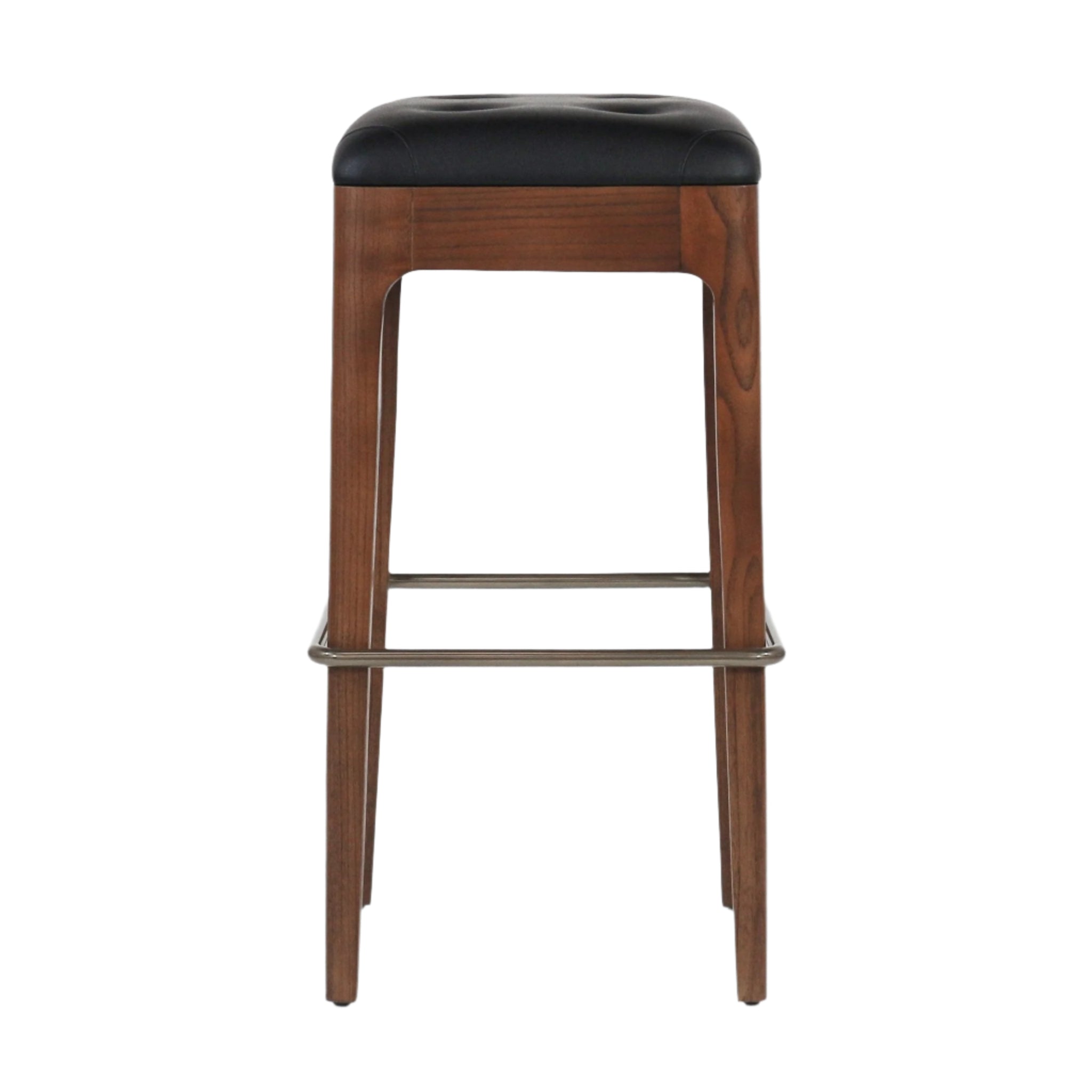 Front-facing backless counter stool with a walnut-finished wood frame, black tufted leather seat cushion and brushed metal footrest/stretcher on a white background.