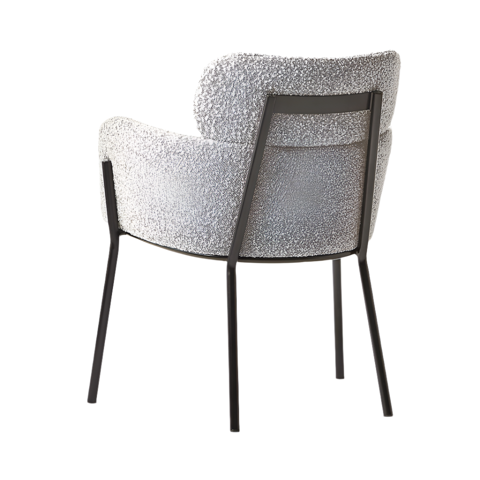 Rear three-quarter view of a grey boucle upholstered dining chair showing its curved padded back and integrated arms, supported by a slim black metal frame and four tapered legs in a modern contemporary style.