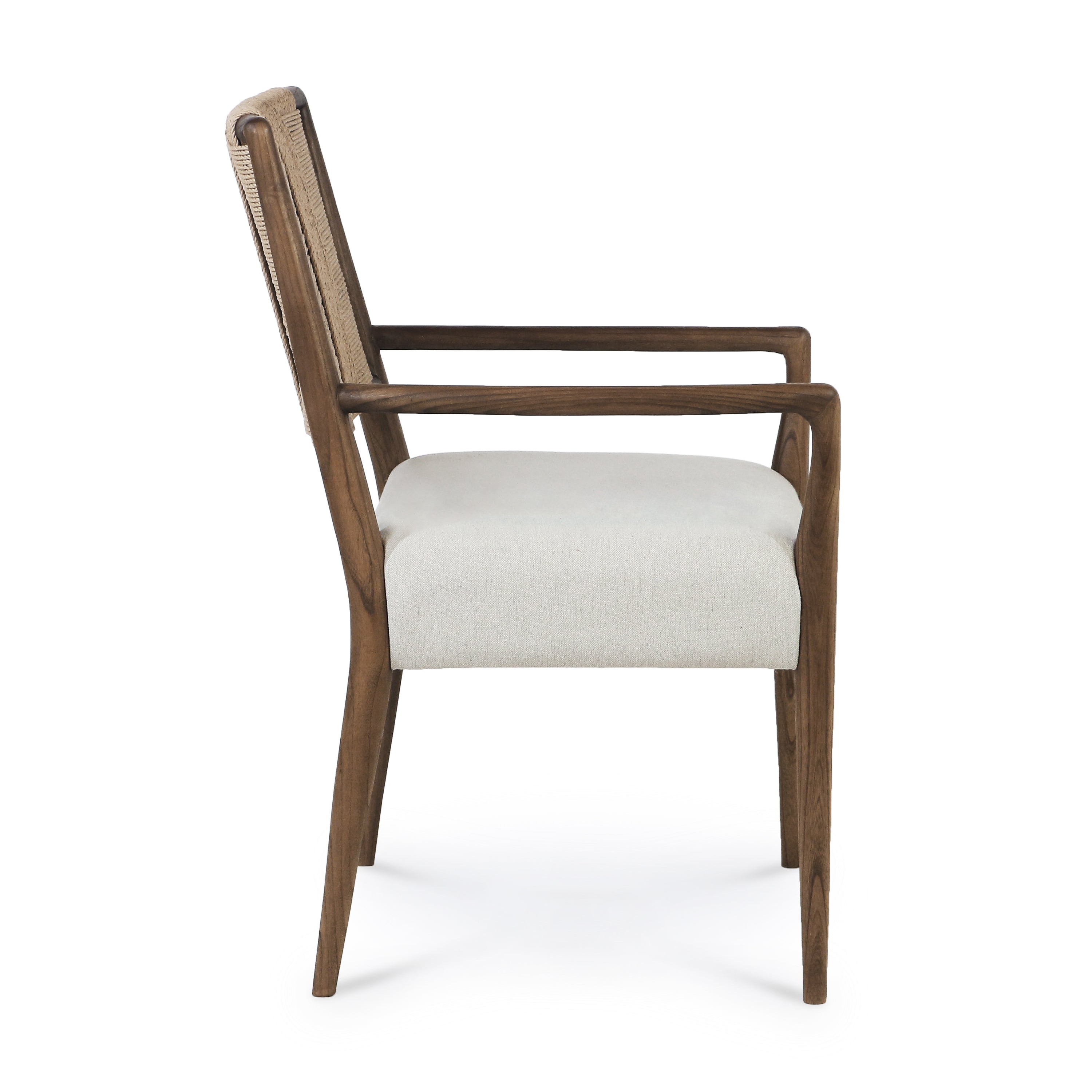 Side profile of a natural solid wood armchair with sculpted frame, woven rope backrest and a light beige upholstered seat on a white background.
