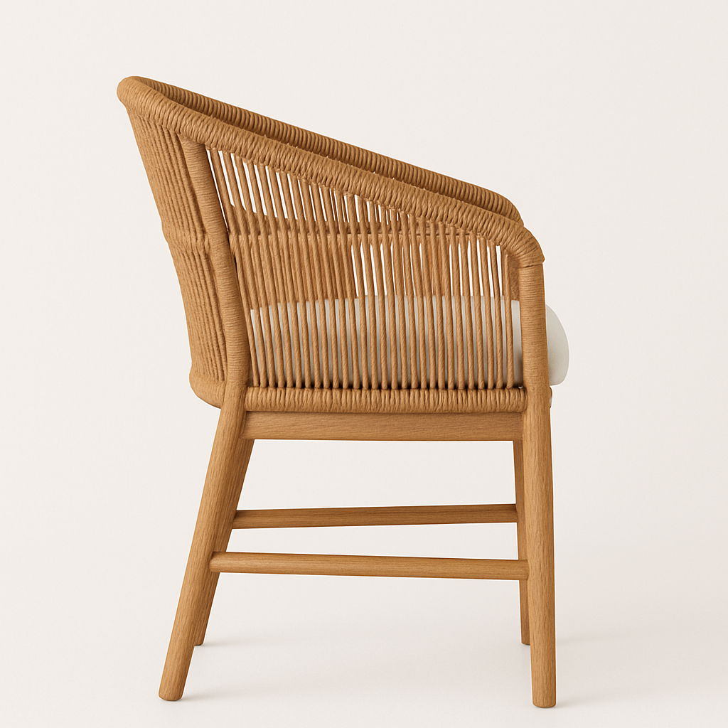 Side view of an outdoor teak dining chair with a woven rope back, solid teak wood frame, angled legs and a cream seat cushion.