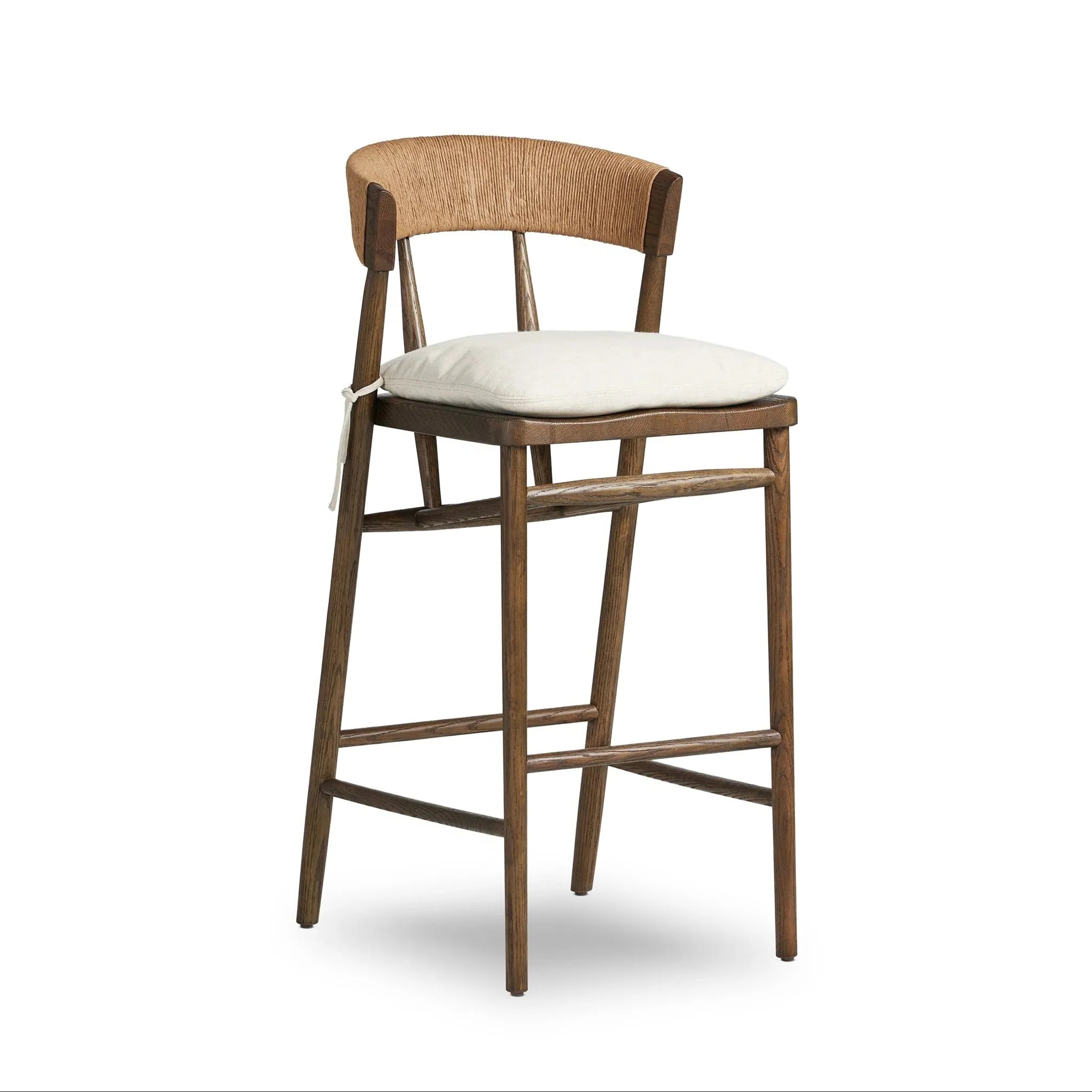 Natural wood rustic counter stool with a woven rope C-shaped back, ivory fabric cushioned seat tied at the side, tapered legs and integrated footrests.