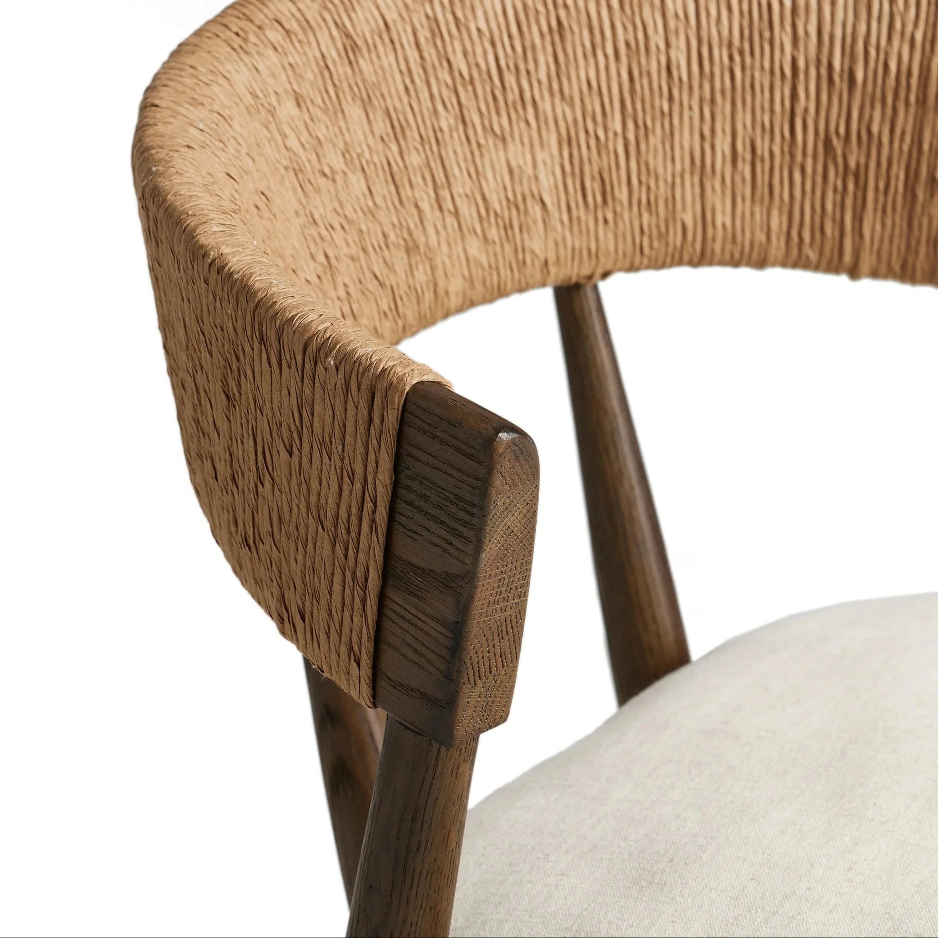 Close-up of a natural rope-wrapped C-shaped backrest on a dark natural wood frame with a light fabric cushioned seat, highlighting the woven rope texture and visible wood grain.