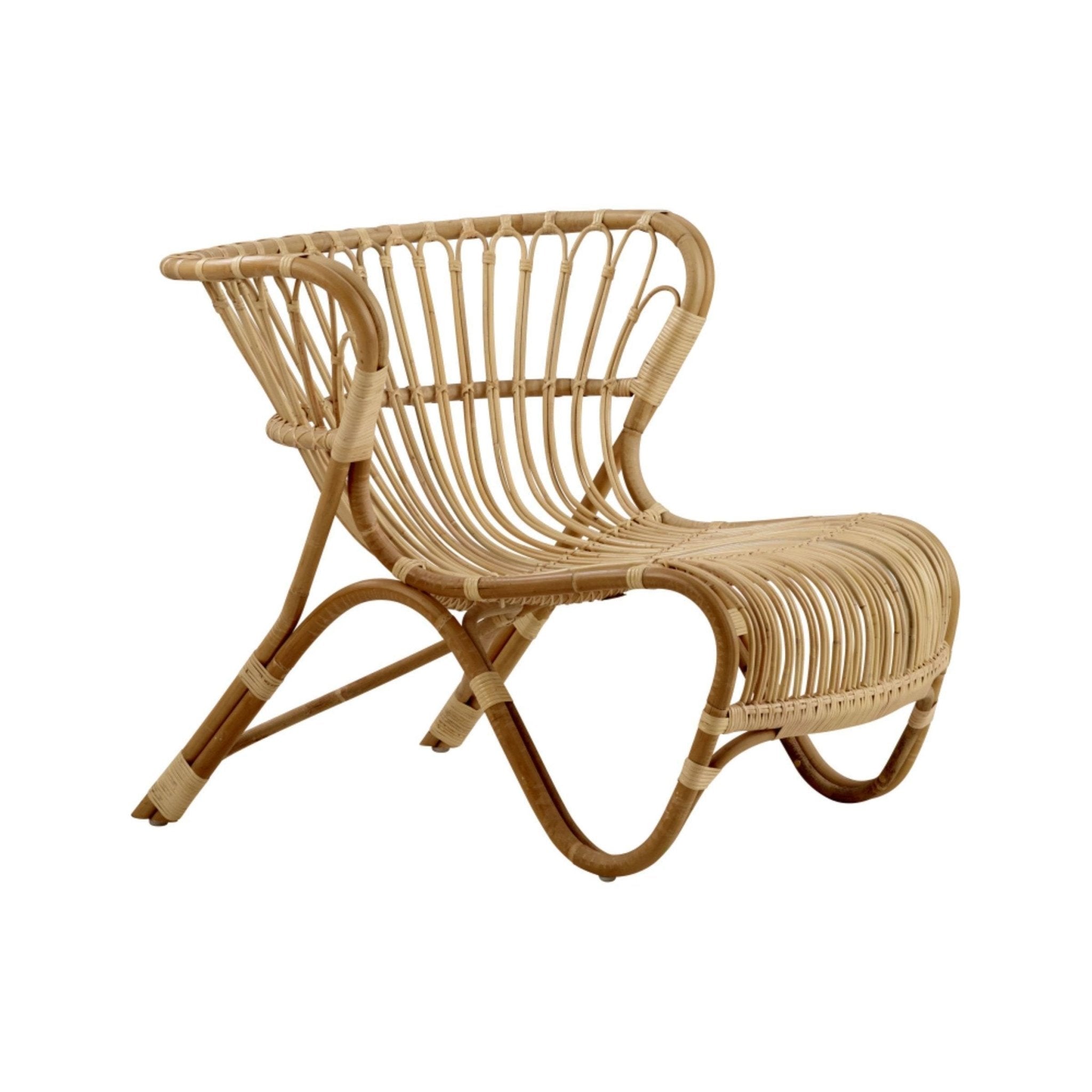 Natural rattan armless lounge chair with curved bent-rattan frame and open woven slat seat and back in a light tan finish, boho-scandinavian style, shown on a white background.