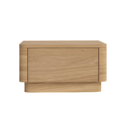 Front-facing solid oak nightstand in a natural finish with a single flush drawer, rounded corners and a recessed plinth base, shown on a white background in a modern minimalist style.