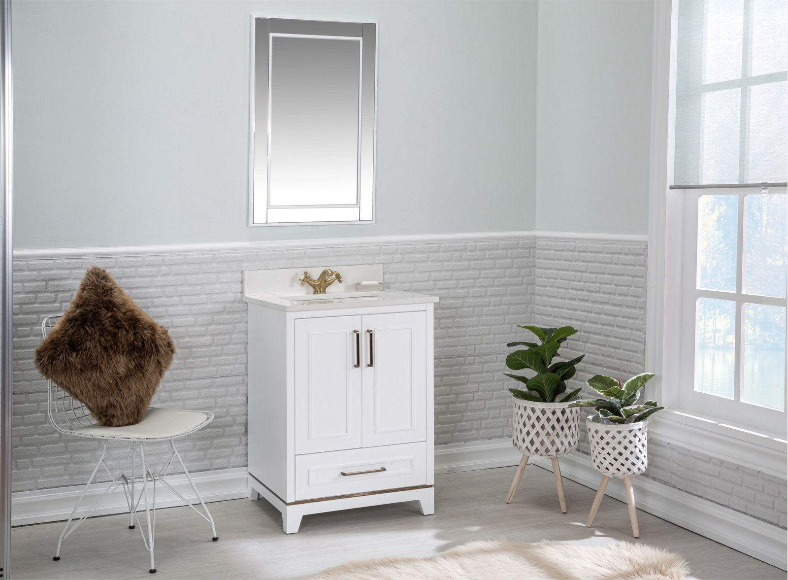 White solid wood single-sink bathroom vanity with a stone countertop and brass faucet, pictured freestanding beneath a rectangular mirror in a modern light-gray bathroom with a fur-covered chair and two potted plants.