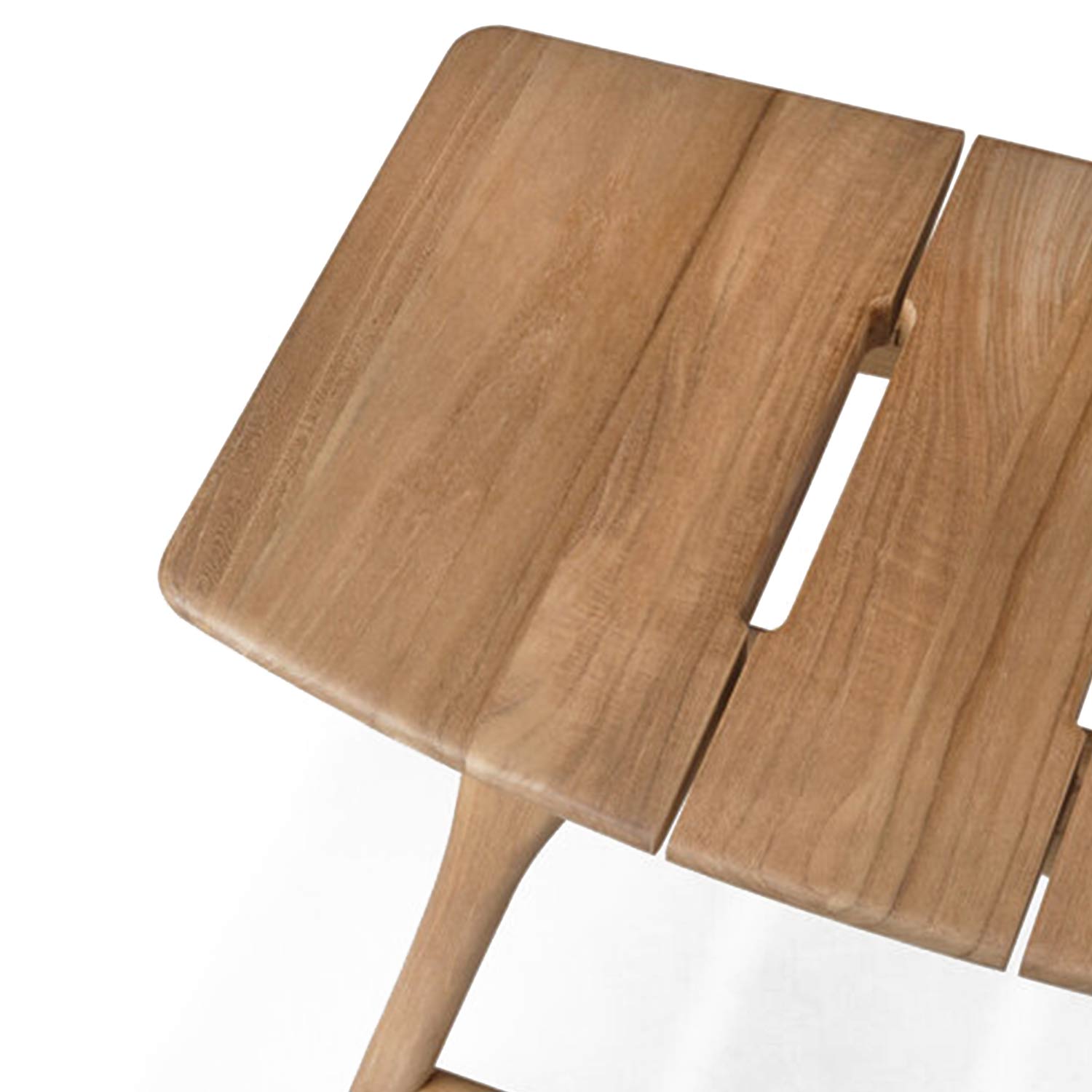 Close-up of a natural teak backless shower stool seat showing smooth slatted planks with a central rectangular slot, rounded beveled edges and a tapered solid-teak leg in a coastal-contemporary finish.