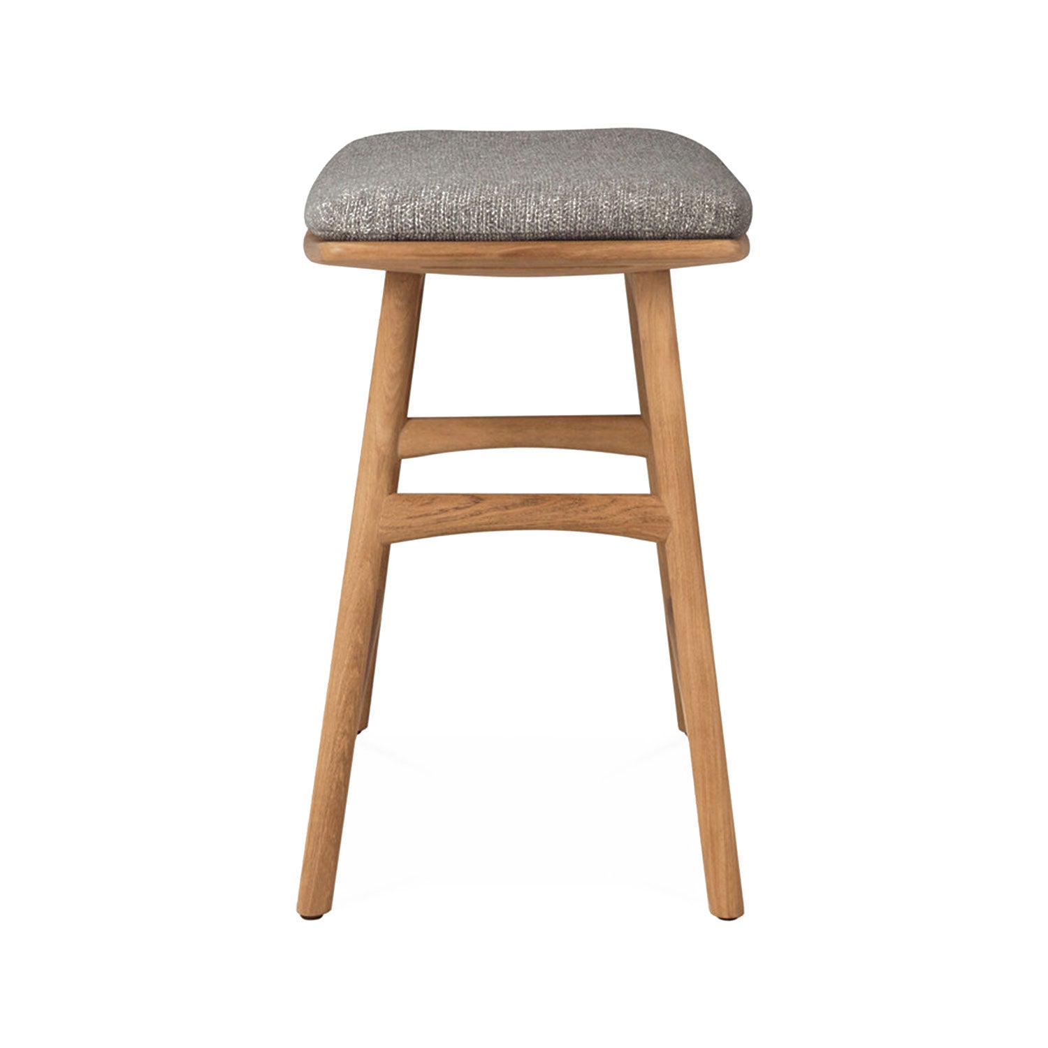 Front view of a backless teak shower stool with a light gray textured upholstered seat cushion, tapered legs and two curved stretchers in a natural teak finish on a white background.