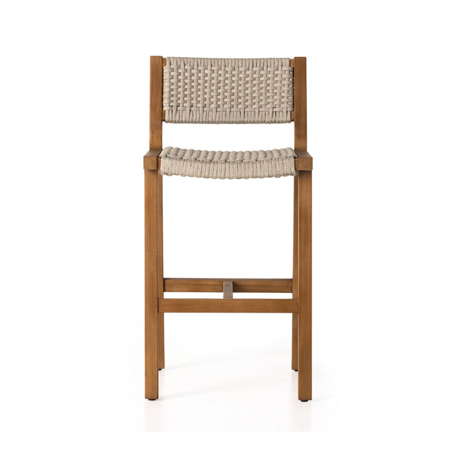 Armless teak outdoor bar stool with a natural solid-wood frame and woven beige rope seat and back, slim square legs and a front crossbar footrest in a coastal style.